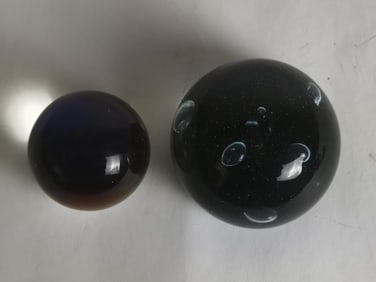 Two Unmarked Glass Paperweights