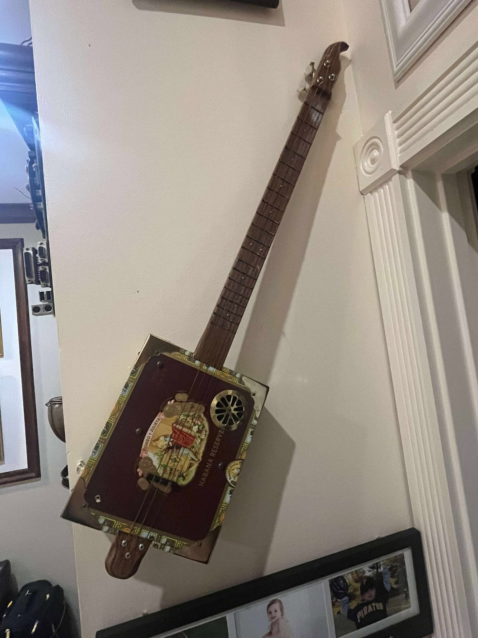 Steve Cinnamon Electric Cigar Box Guitar: Steve Cinnamon (Electric Cigar Box Guitar) 1" x 2" oak neck romeo, Cigar box, 3 string and fully electric. Approximately 36" long. COA. RMS