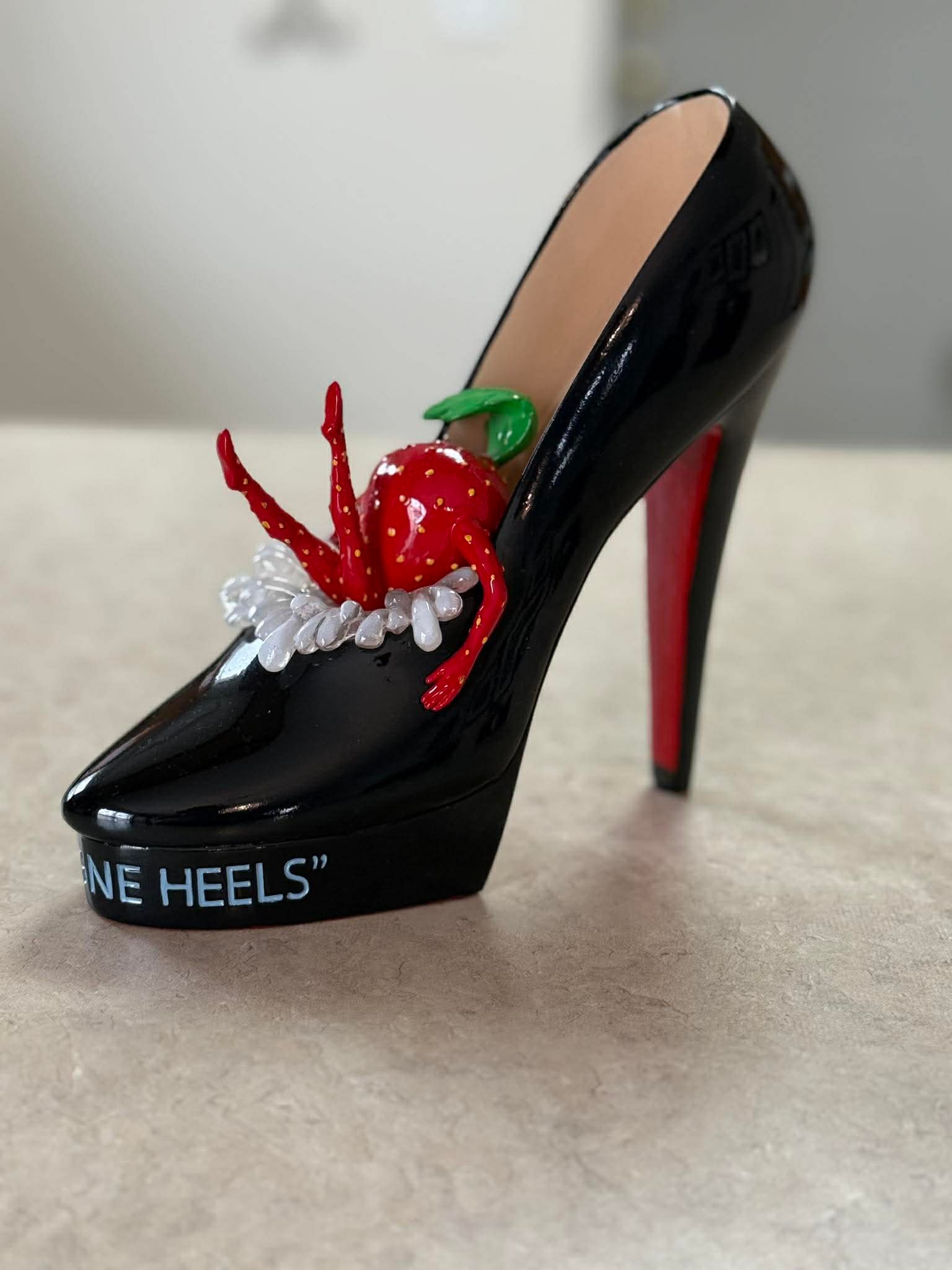 Michael Godard Champagne heels: Michael Godard "Champagne Heels" 2023 7" x 3" x 6 1/2" Hand-painted sculpture in resin. Hand-signed in pigment by the artist. Appraisal.