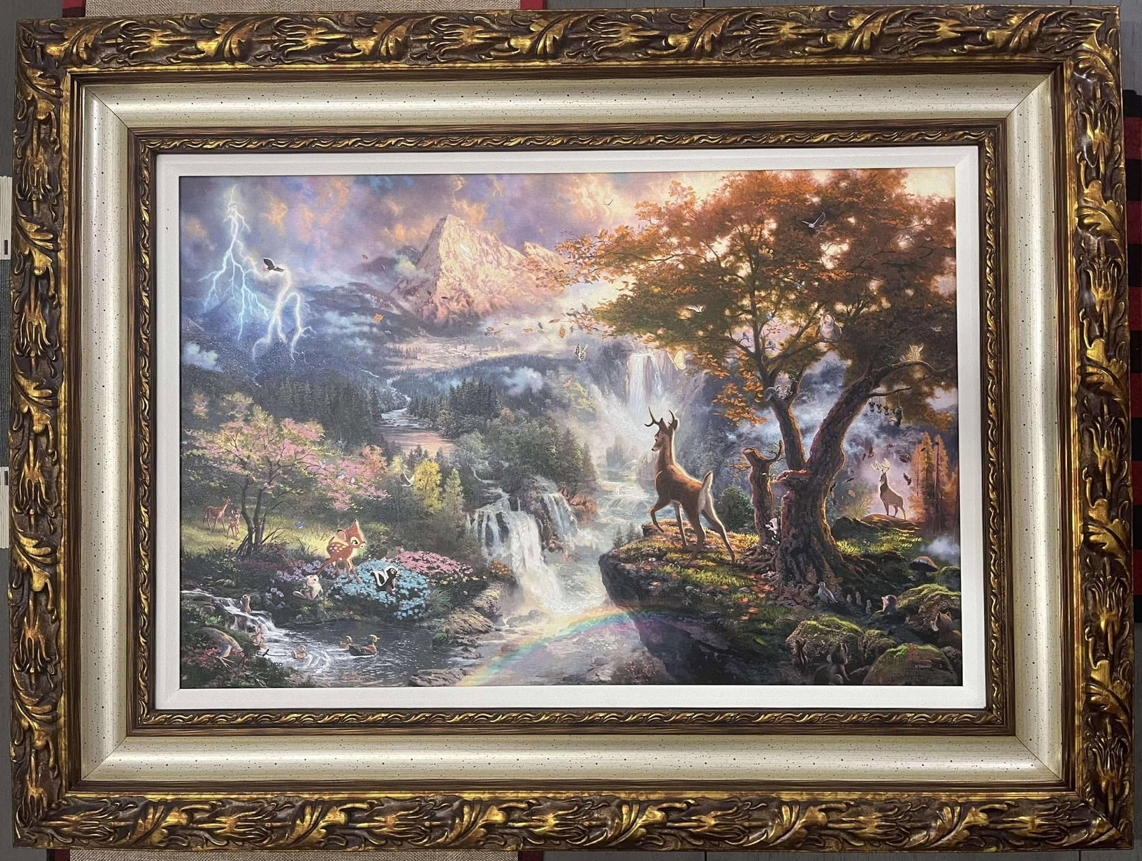 Thomas Kinkade Bambi's First Year MD: Thomas Kinkade "Bambi's First Year" (MD) 2010 18" x 27" Image size Giclee in color with acrylic embellishments on canvas. Signed with the artist's authorized signature applied through the artist's