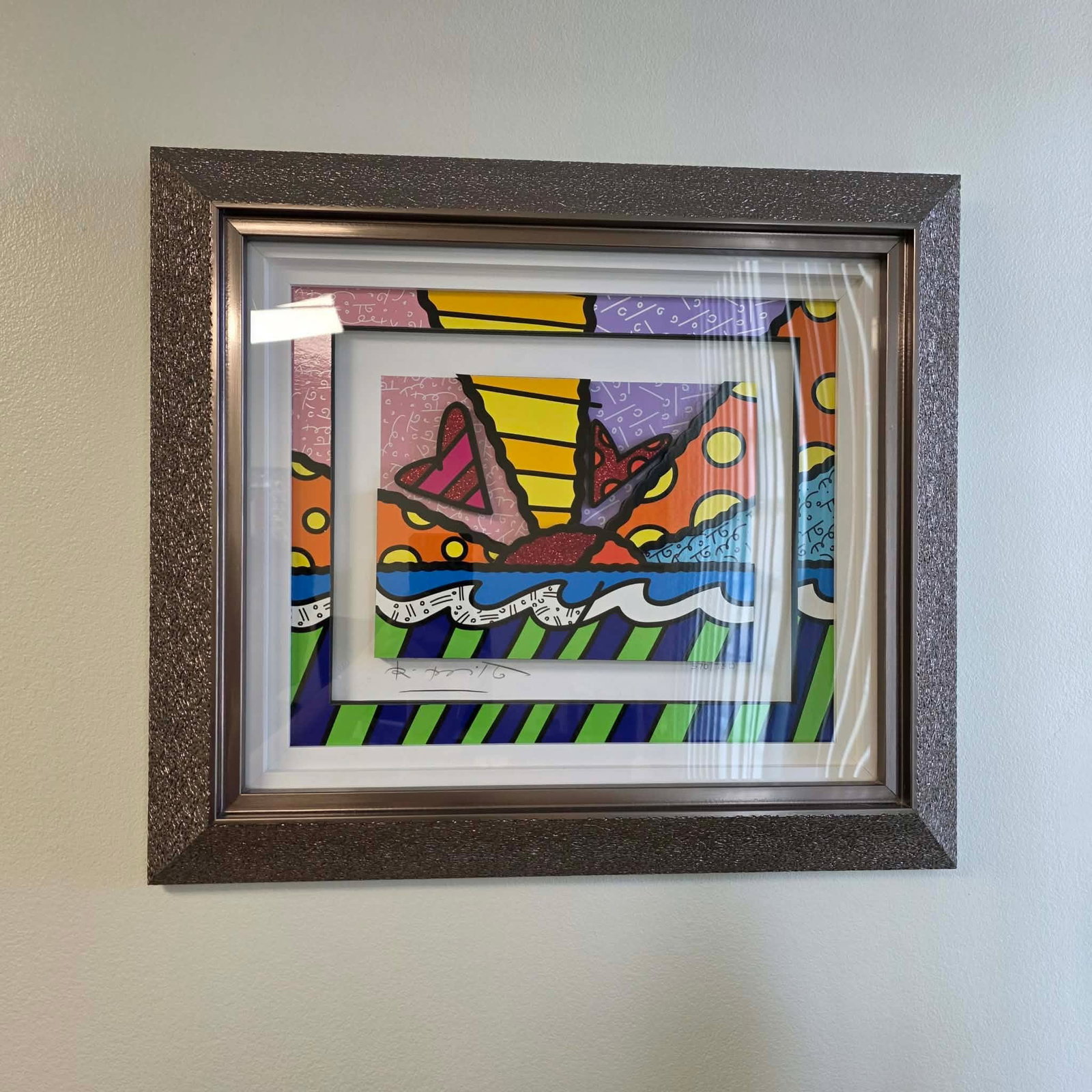 Romero Britto Heart Sunrise: Romero Britto "Heart Sunsire" 2016 13" x 15 3/4" image size Three-dimensional serigraphy construction in color with cut-outs in serigraphy. Signed in pencil lower left by the artist. Gallery framed,