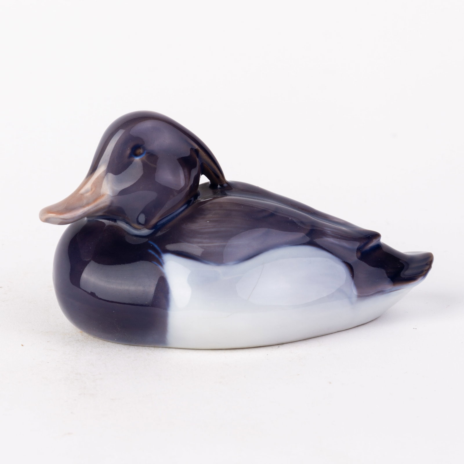 Royal Copenhagen Fine Porcelain Tufted Duck Figure by Peter Herold: DIMENSIONS APPROX 11x6.5x6CM.