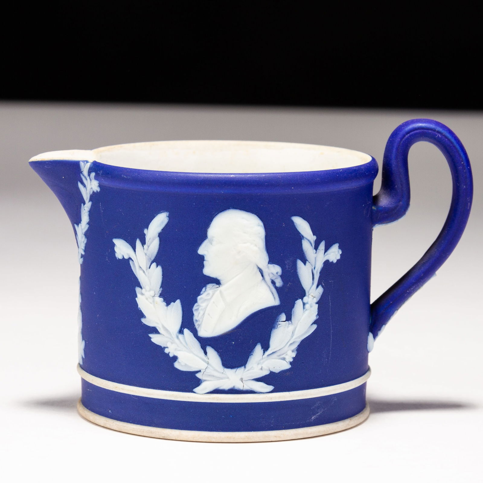 Josiah Wedgwood Dark Blue Jasperware Portrait Cream Jug: MEASURES APPROX 11 x 7.5cm.