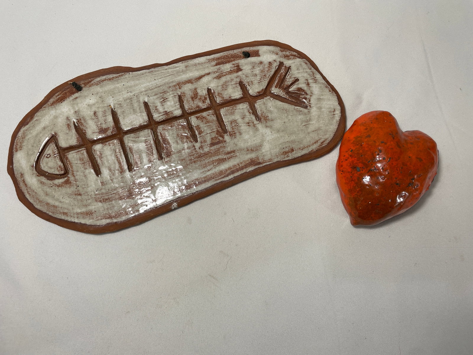 - Custom Pottery Art Pieces: Fish Wall Clay Art is signed "J Ward" and measures 15.5" x 8" x .5", Clay Heart Wall Art is signed "JW" and measures 5" x 5.5" x 2.5" D.