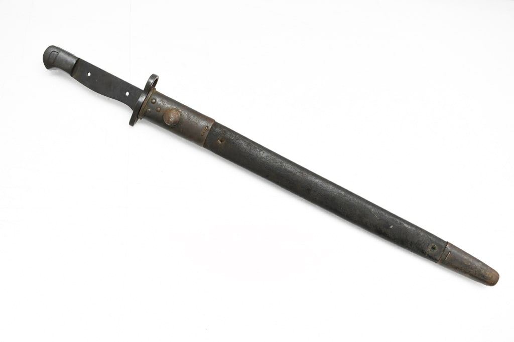 British Pattern 1907 Bayonet (16.75" Blade) W/ Scabbard - James A. Chapman (Missing Grips): This sword/bayonet was designed to be used with the British Short Magazine Lee Enfield (SMLE) rifle. SPECS: Missing grips, 16.75" blade, 21.5" overall length and brown leather scabbard with metal fitt