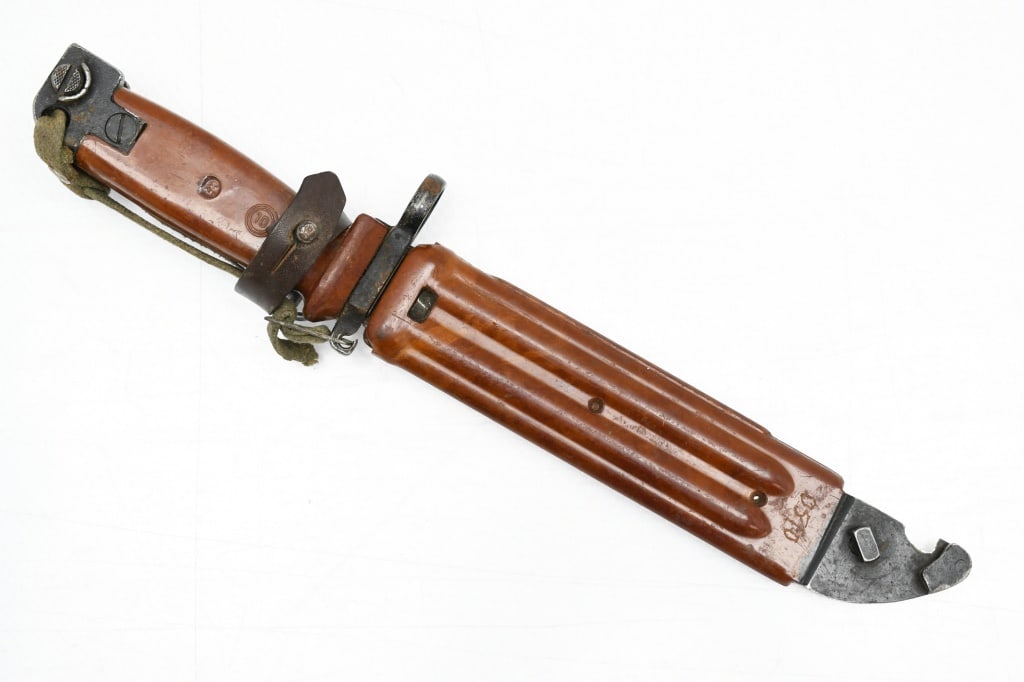 AKM Type II Bayonet (5.8" Blade) W/ Type II Scabbard & Loop Hanger: This knife/bayonet is for use with the 7.62mm Kalashnikov AKM assault rifle. SPECS: 5.8" blade with teeth, 11" overall length, orange plastic grip, orange plastic Type II scabbard with wire cutter and