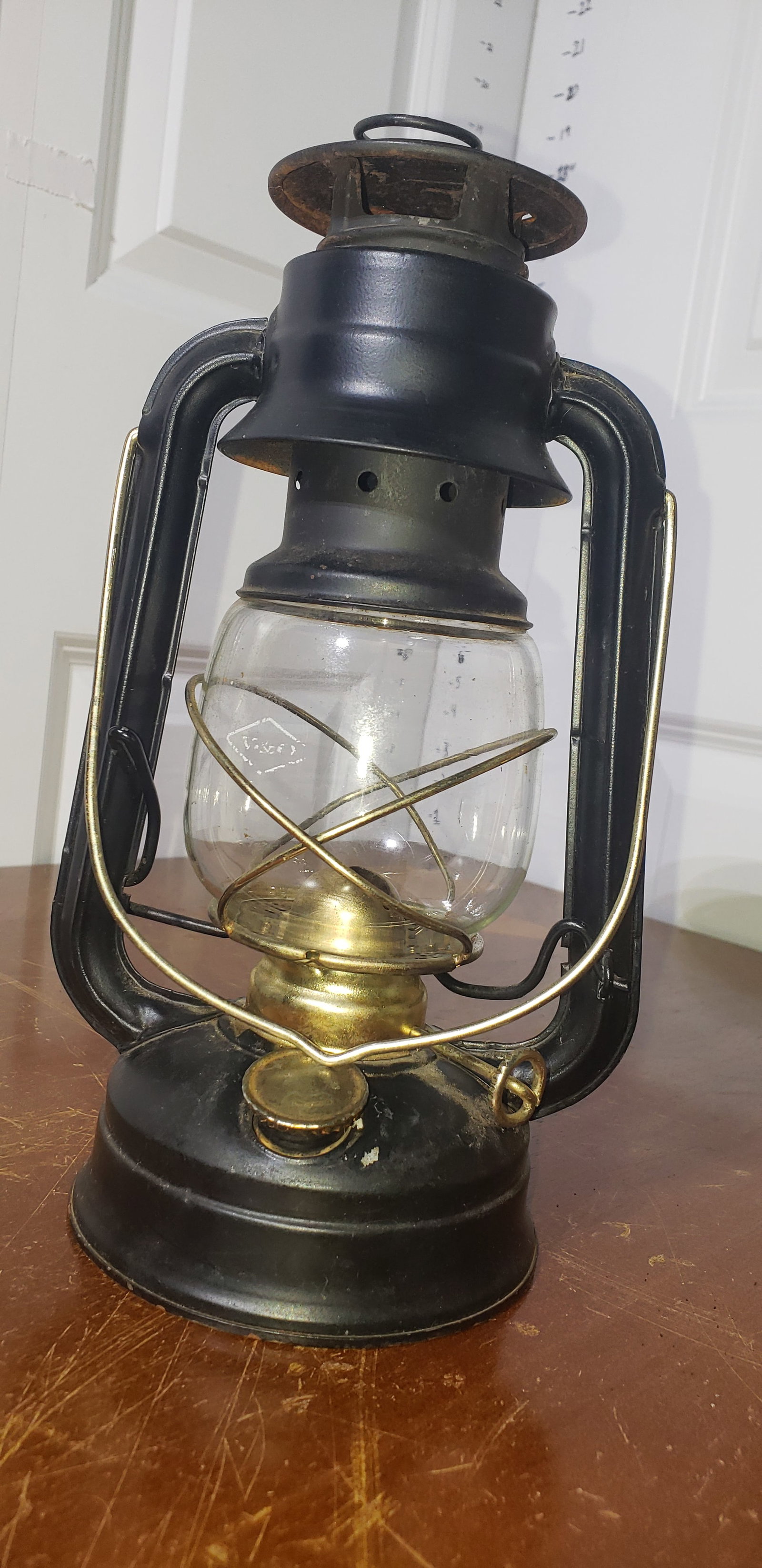oil lamp: black & gold kerosene lantern, worn company logo on front of glass jug, ~12?H overall