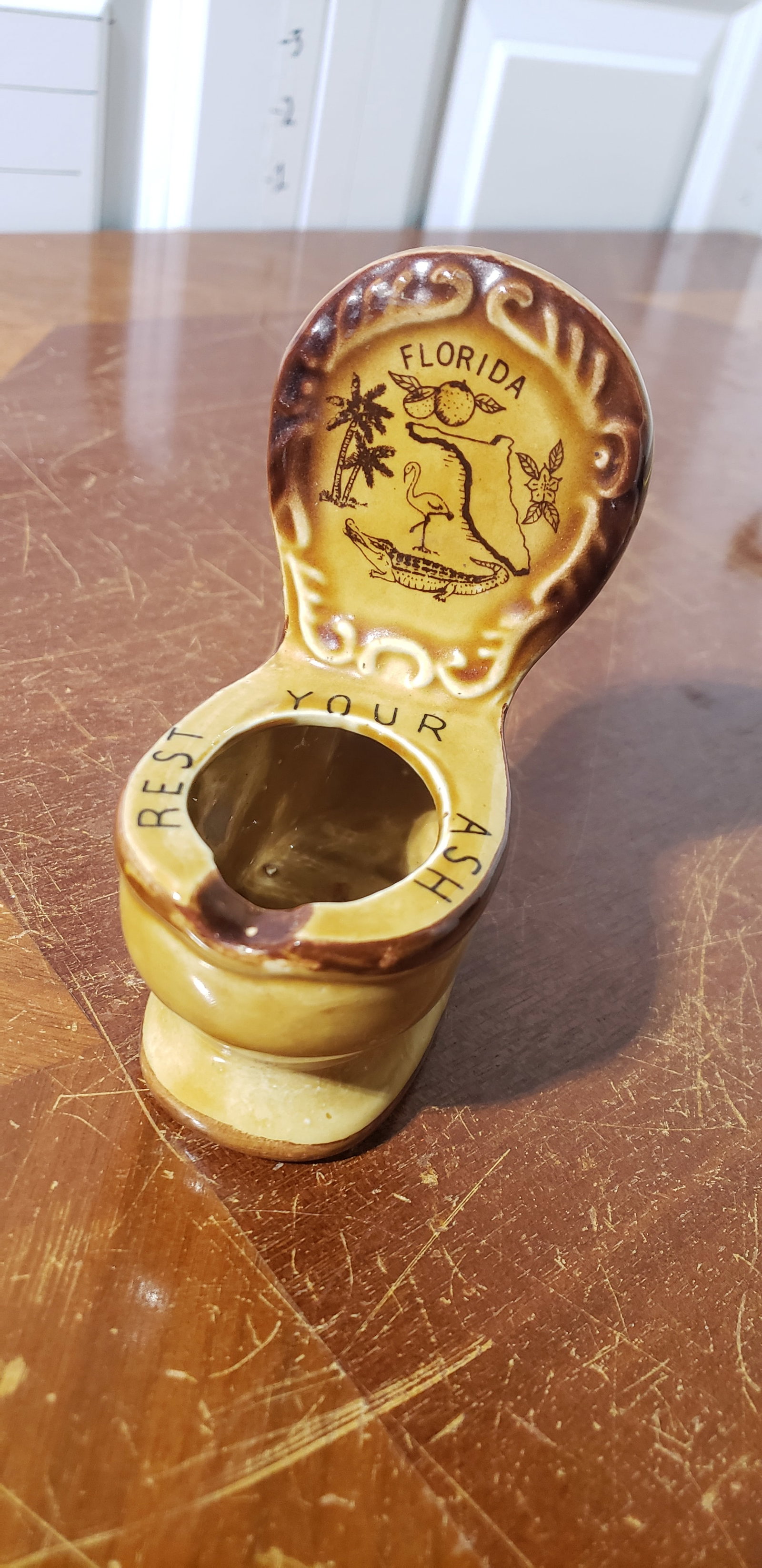 novelty ashtray: small novelty ceramic FL toilet ashtray, brown-wash-painted, ~2-1/2?L