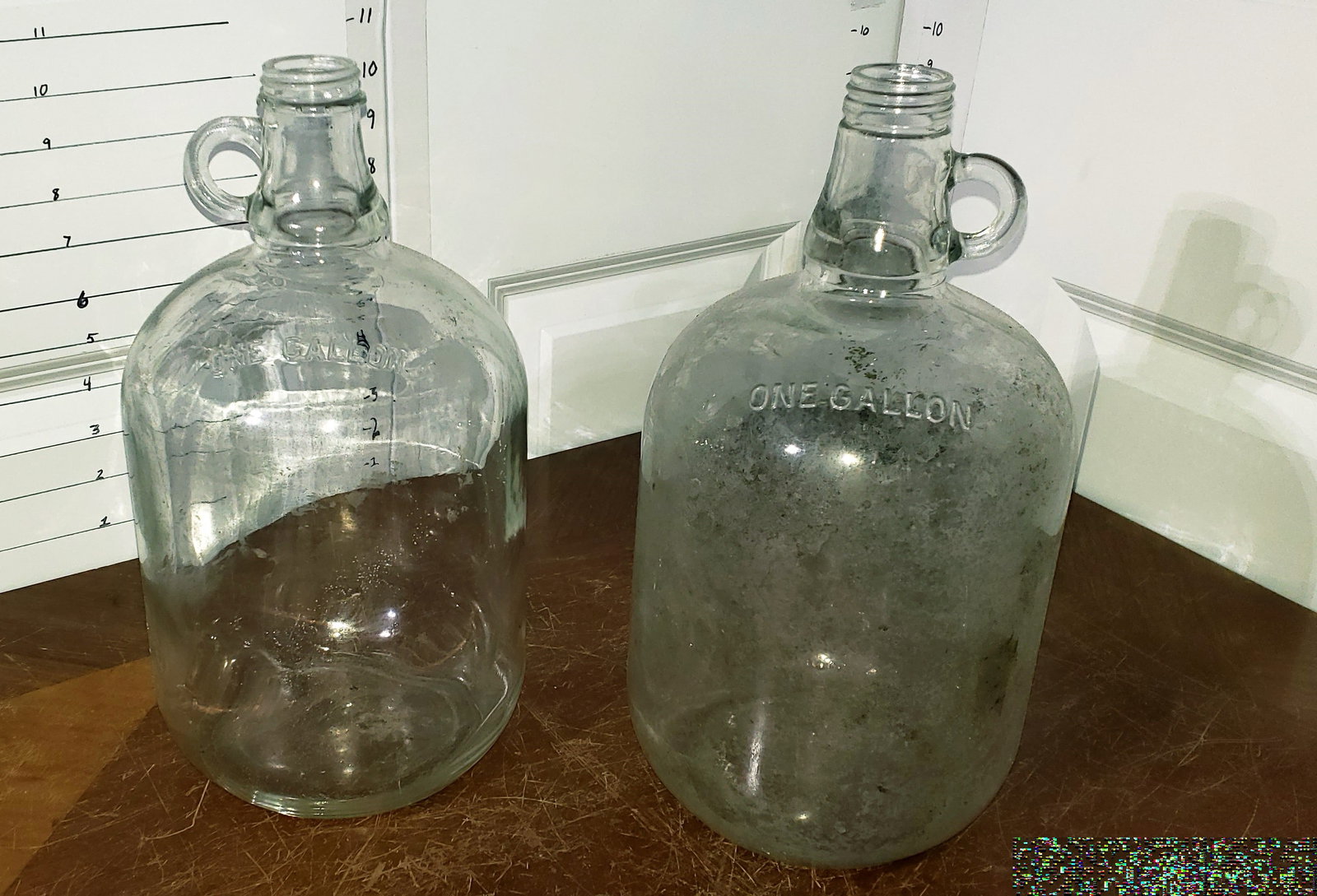 moonshine jugs: pair of large clear glass gallon "moonshine" jugs, one decently clean while other has more sediment residues inside, reclaimed from marsh during property cleanup, may still require further cleaning, r