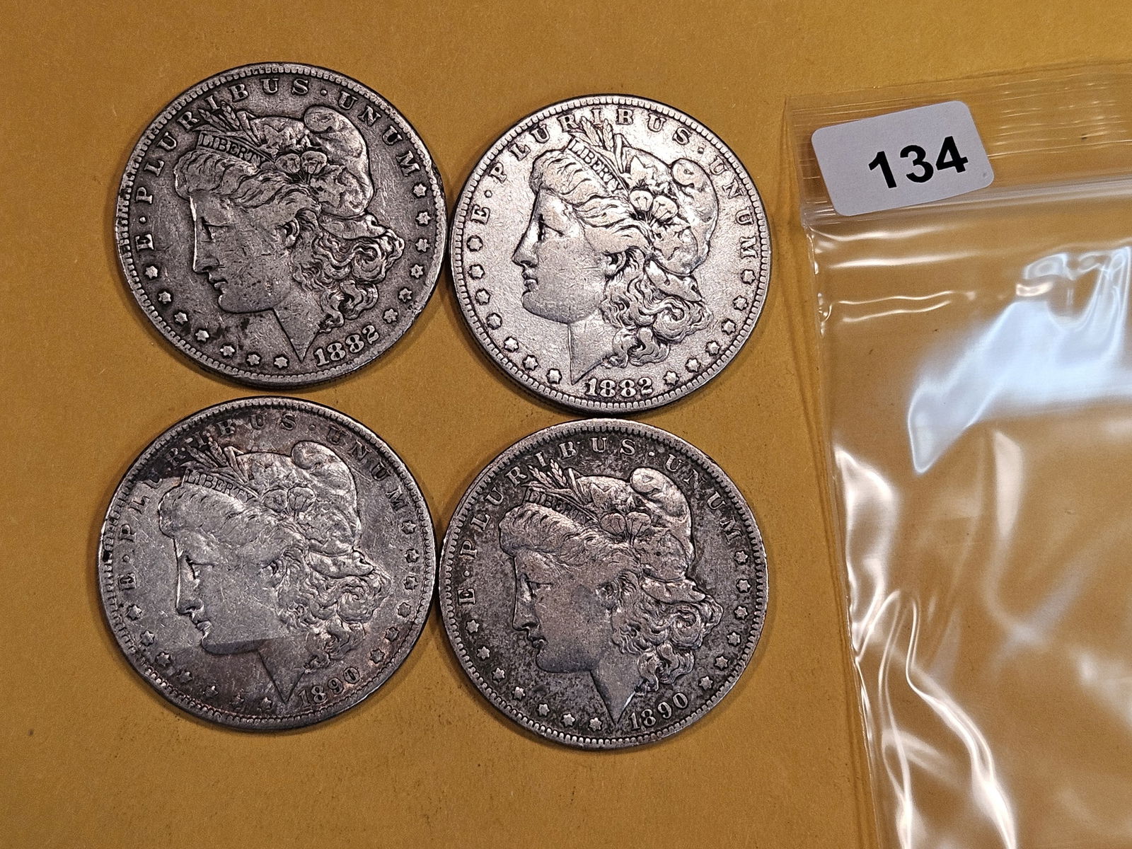 Four mixed Morgan Silver Dollars (1 of 2)