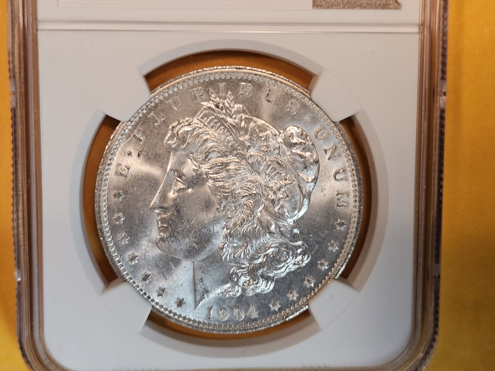 NGC 1904-O Morgan Dollar in Mint State 64: Satiny