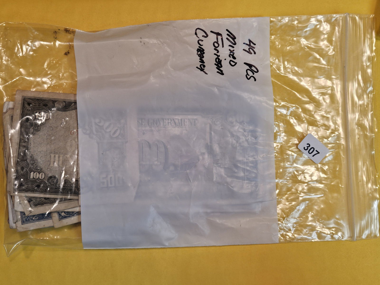 Forty-nine pieces of mixed World Currency (1 of 2)