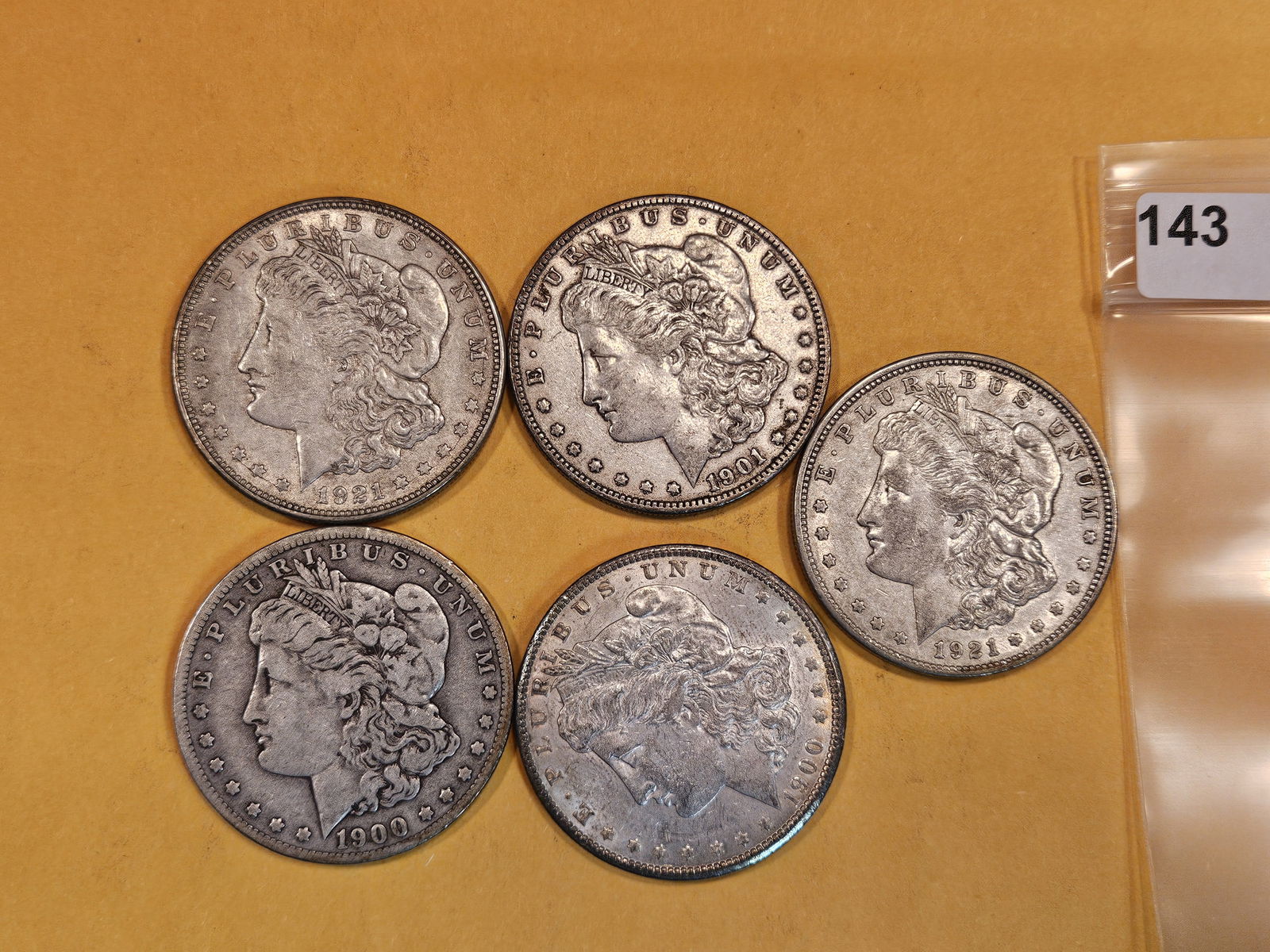 Five mixed Morgan Silver Dollars (1 of 2)