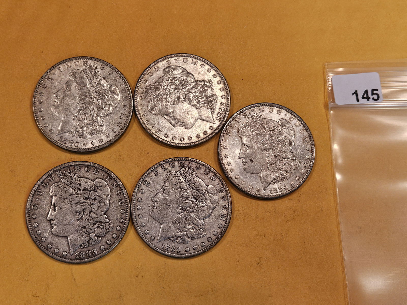 Five mixed Morgan Silver Dollars (1 of 2)