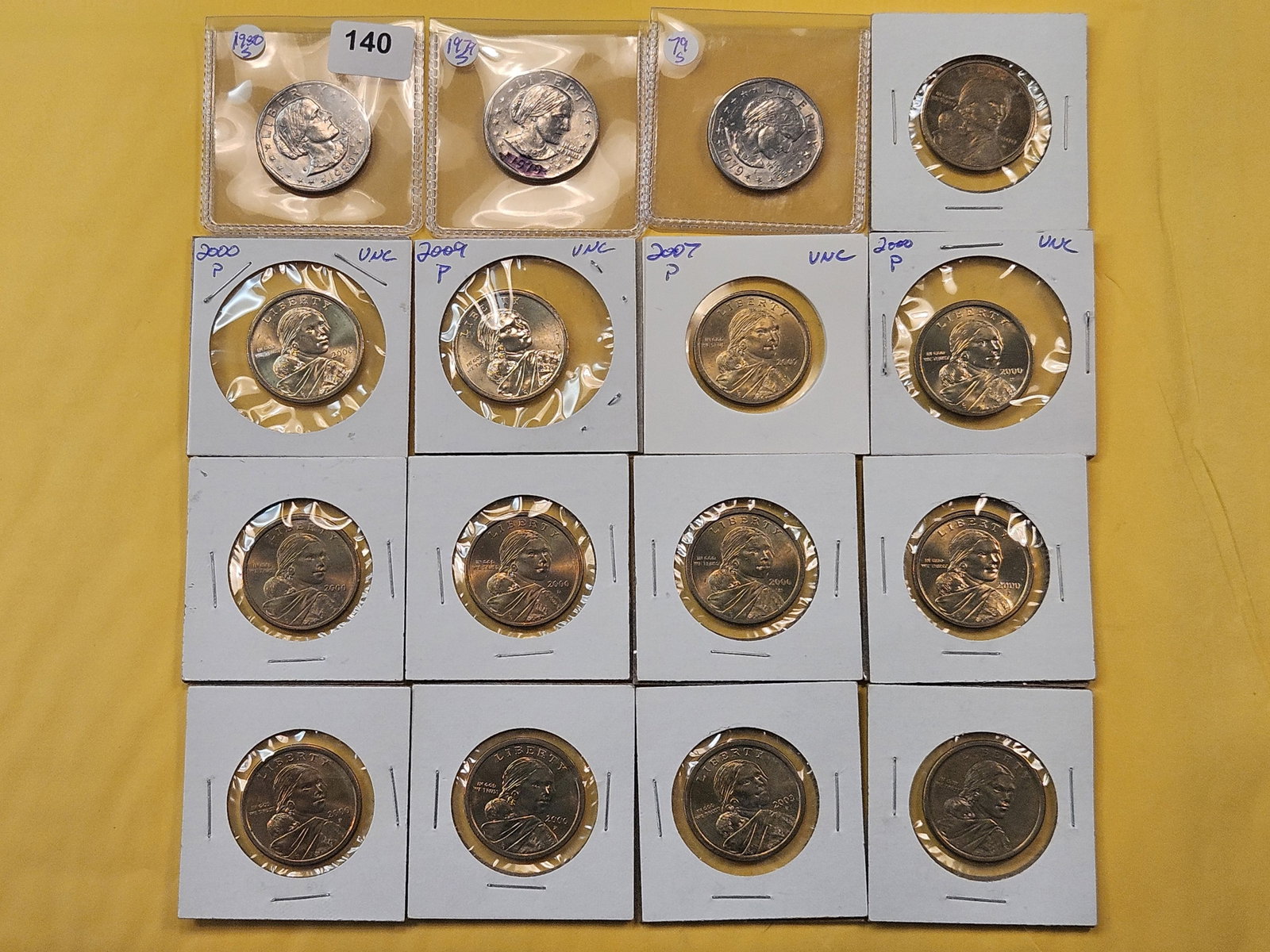 Sixteen Modern One Dollar Coins: Three Susan B. Anthony Dollars and thirteen Sacagawea Dollars.