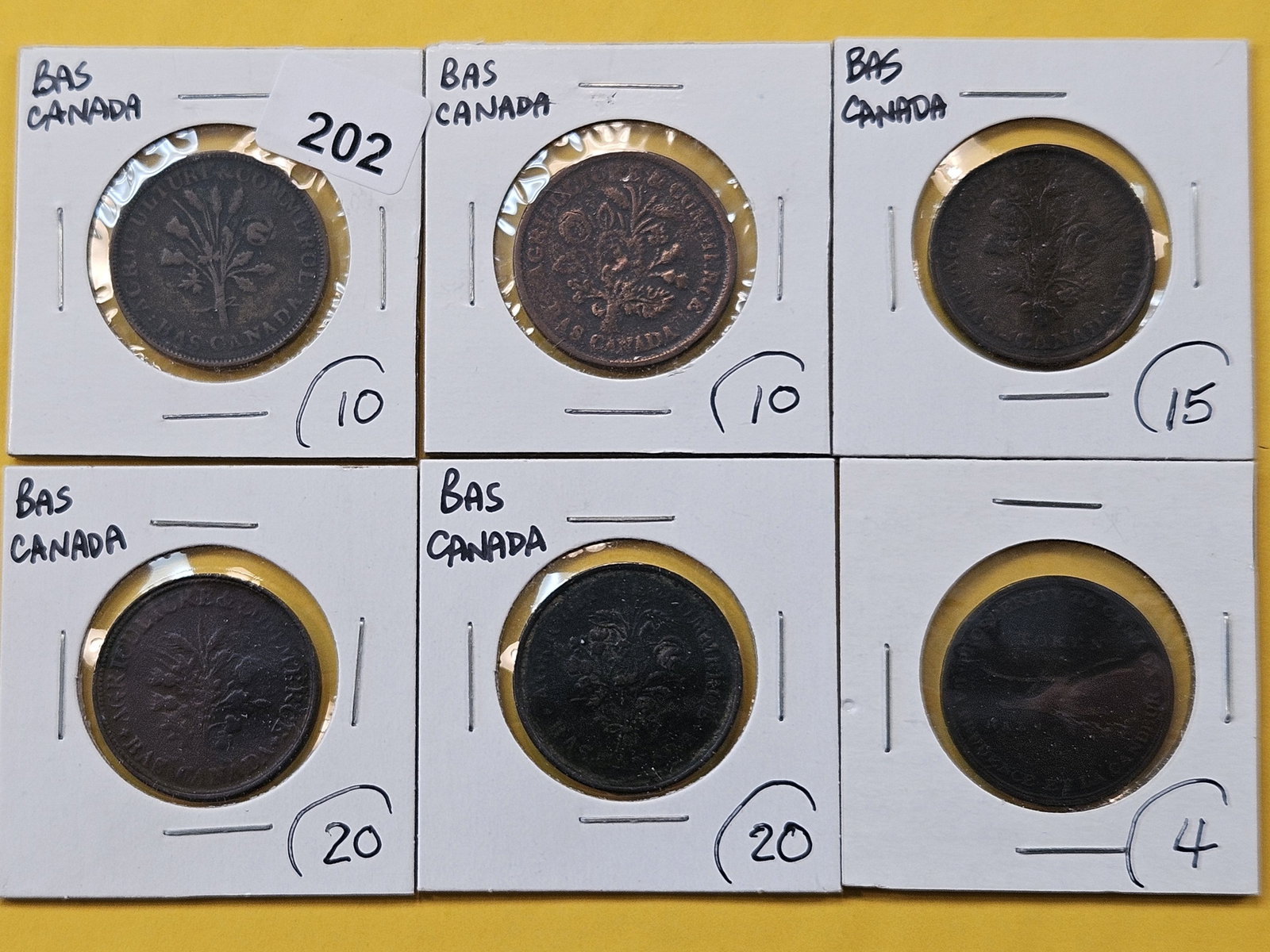 Six Canadian Bank Tokens: Five Un Sol tokens and a Half Penny