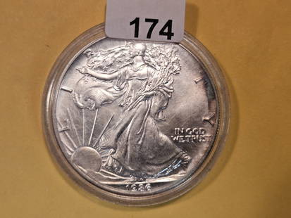 KEY DATE! GEM Brilliant Uncirculated 1986 American Silver Eagle: Toned. In plastic capsule