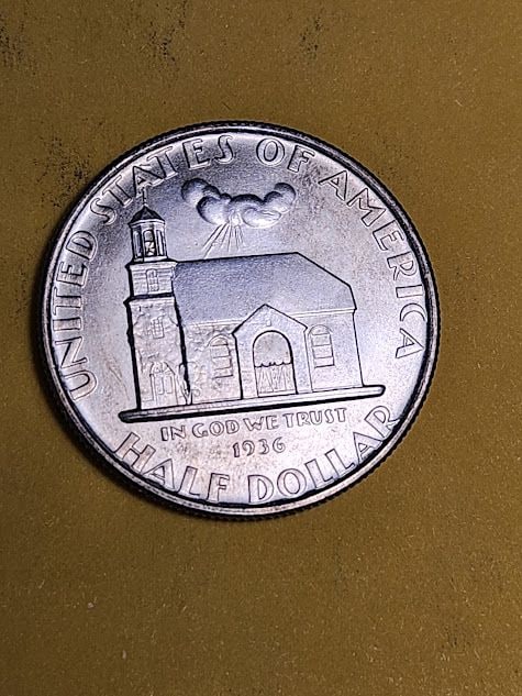 Very Choice Brilliant Uncirculated 1936 Delaware silver Commemorative Half Dollar: Brilliant luster and a graceful cartwheel effect flow across the surfaces, highlighting the ship that carried Delaware into history. A whisper of caramel toning rests just beside the sails, so subtle