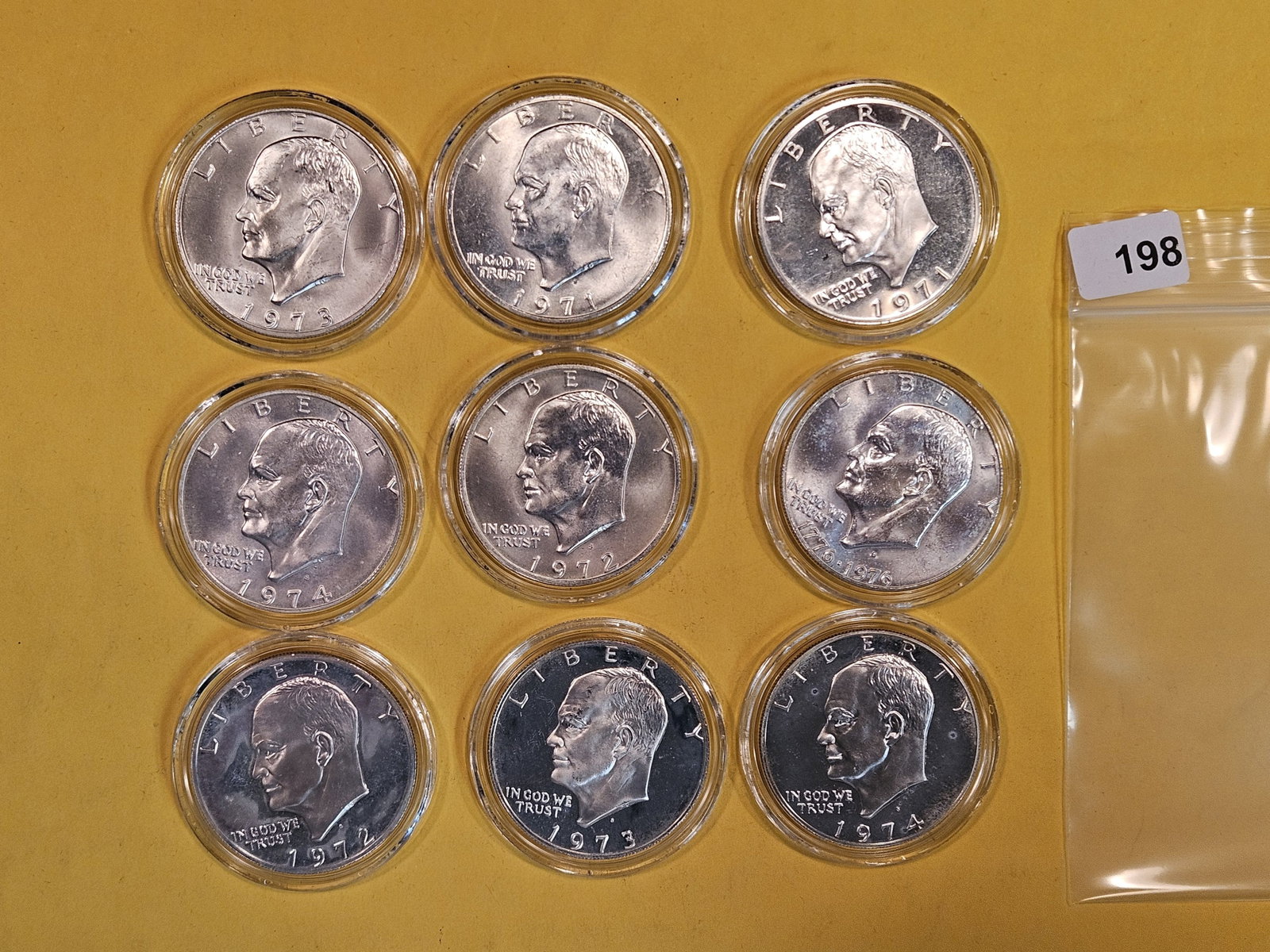 Nine SILVER Proof and BU Eisenhower Dollars: All in original plastic capsules