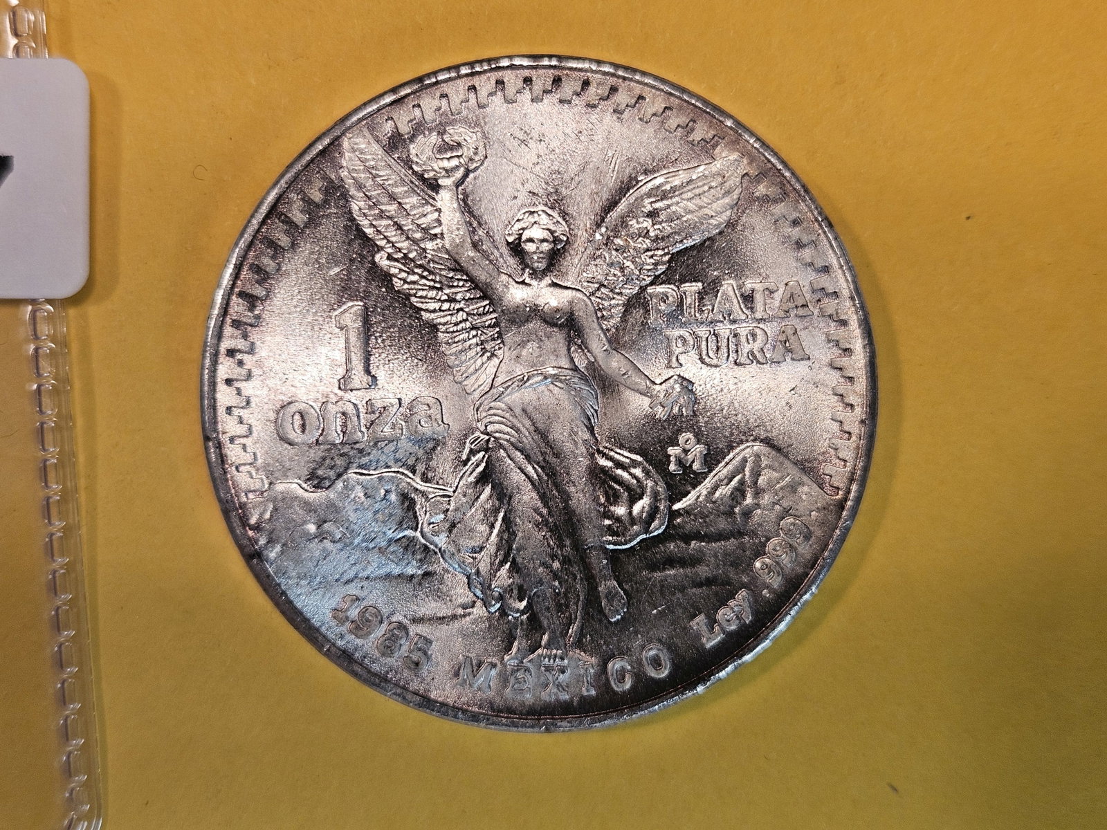 GEM Brilliant Uncirculated 1985 Mexico silver one Onza: Libertad. Lightly toned