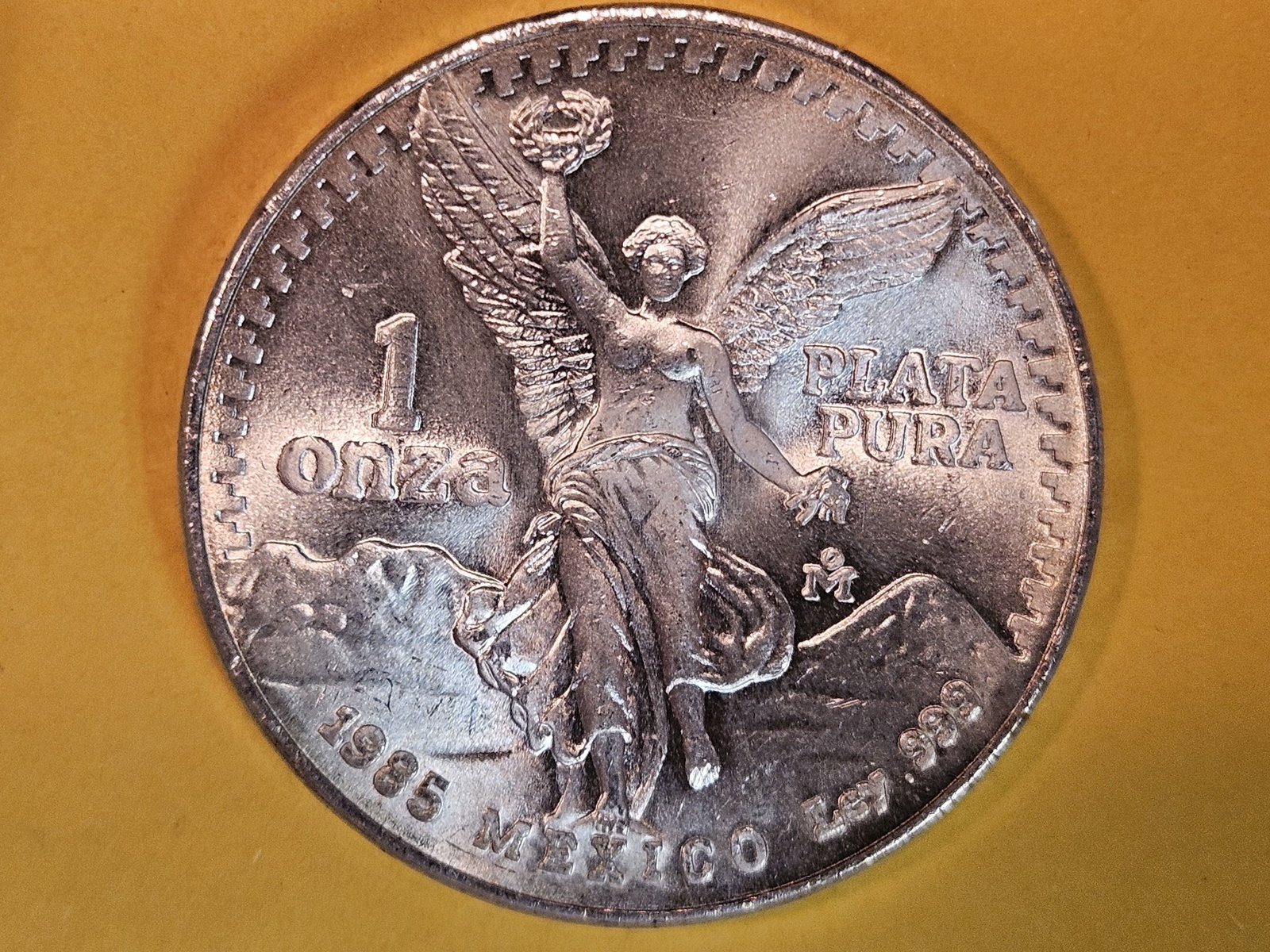 GEM Brilliant Uncirculated 1985 Mexico silver one Onza: Libertad. Lightly toned