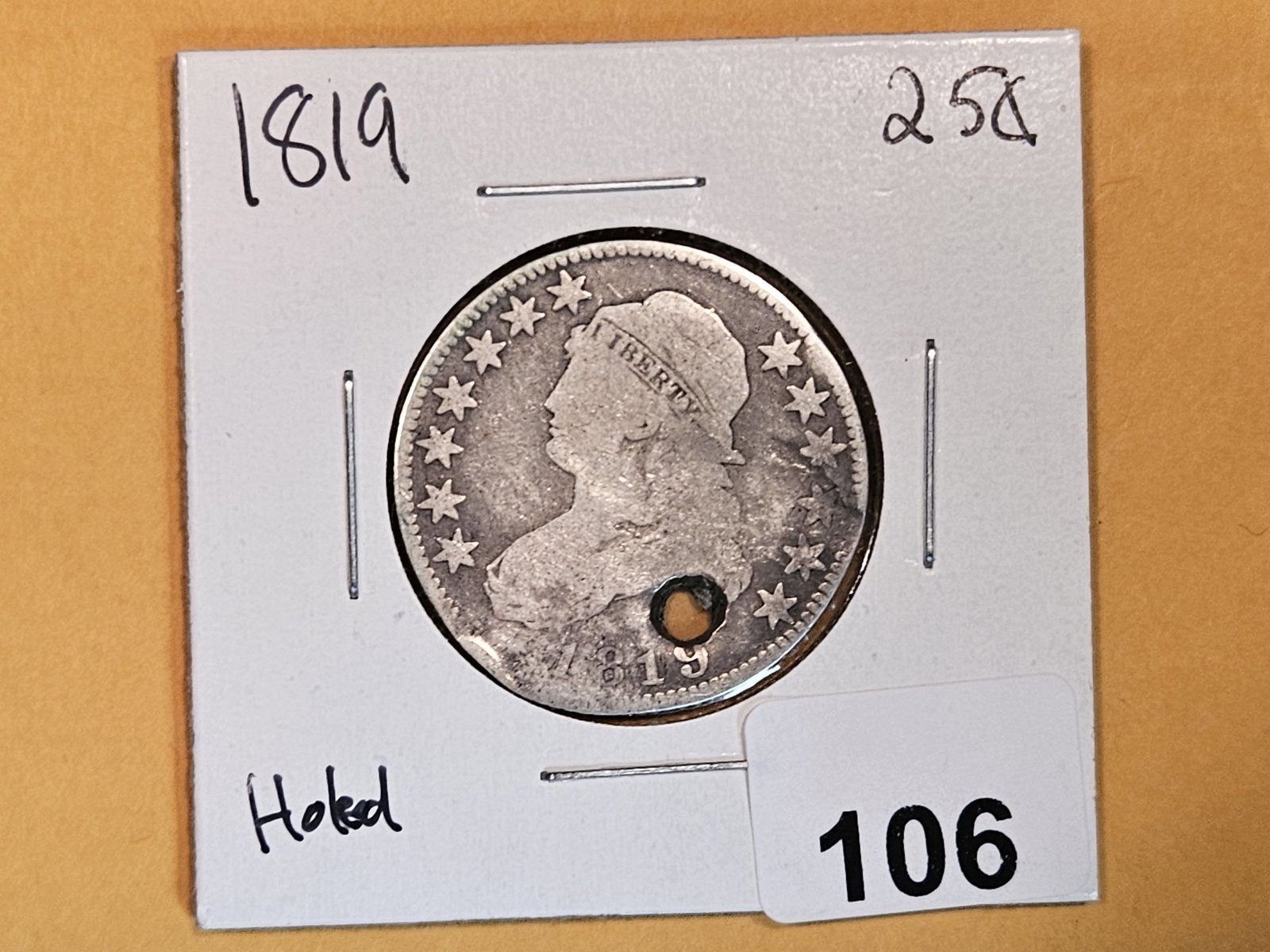 1819 Capped Bust silver quarter: Welp…she's a rare coin….and rather religious…..she's quite holey