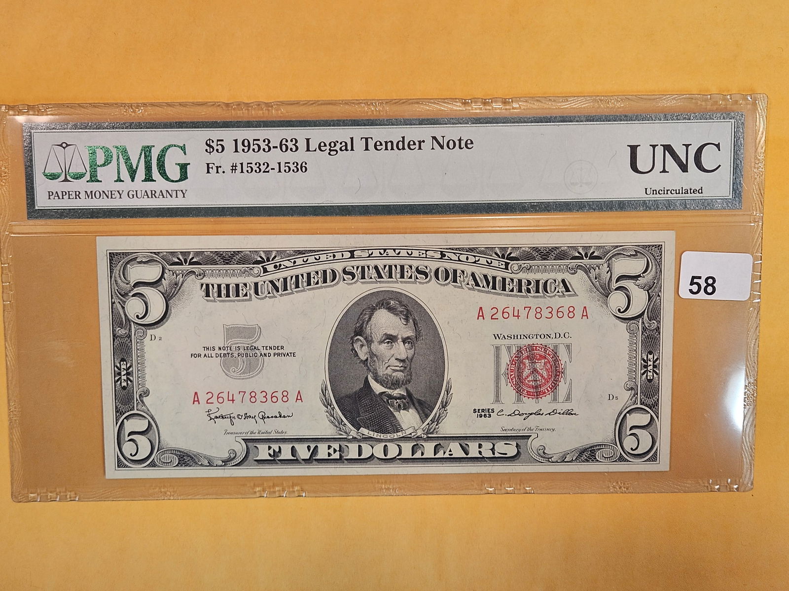 PMG 1963 US Legal Tender Note in Uncirculated: Red Seal. I guess it's just too tough to give it an actual grade or write the exact date (which says 1963 on the paper) on the label?