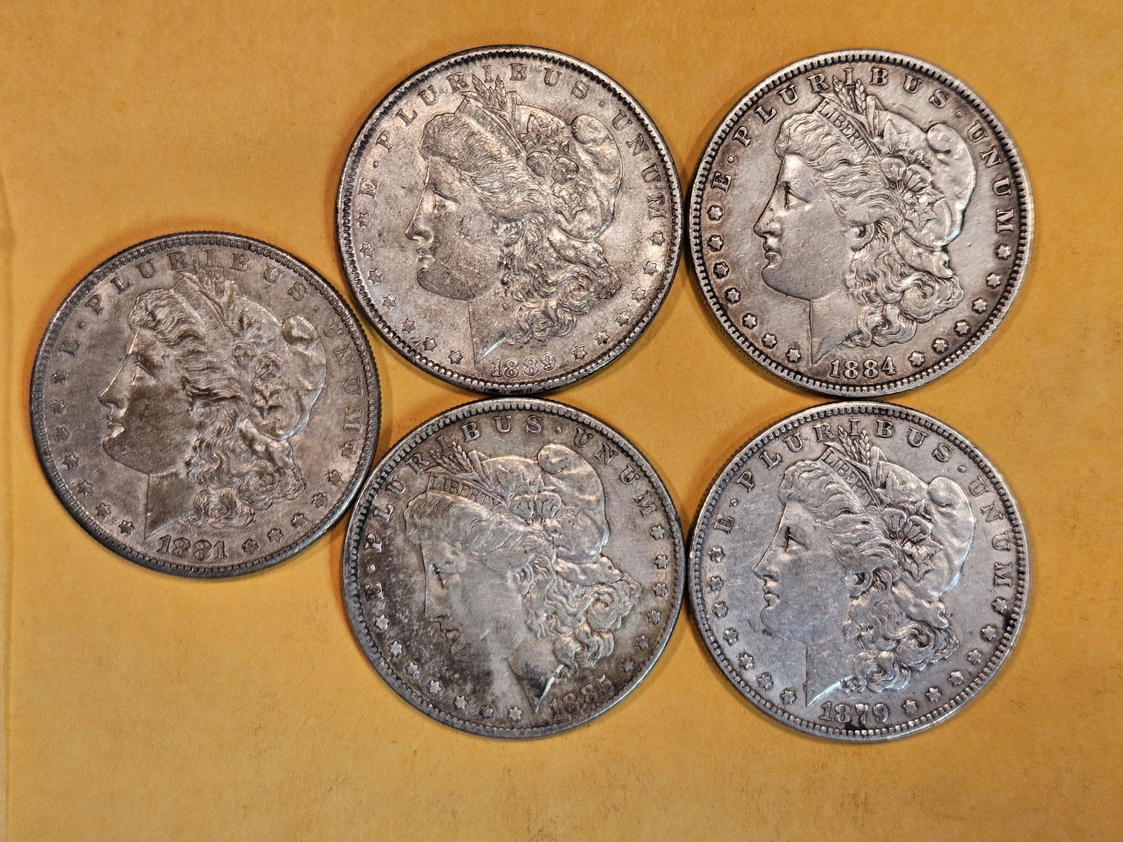 Five mixed Morgan silver Dollars (1 of 3)