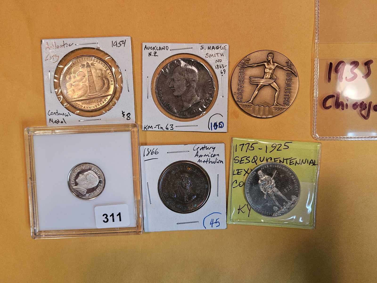 Six better mixed pieces of exonumia: Late 1800 and early 1900s