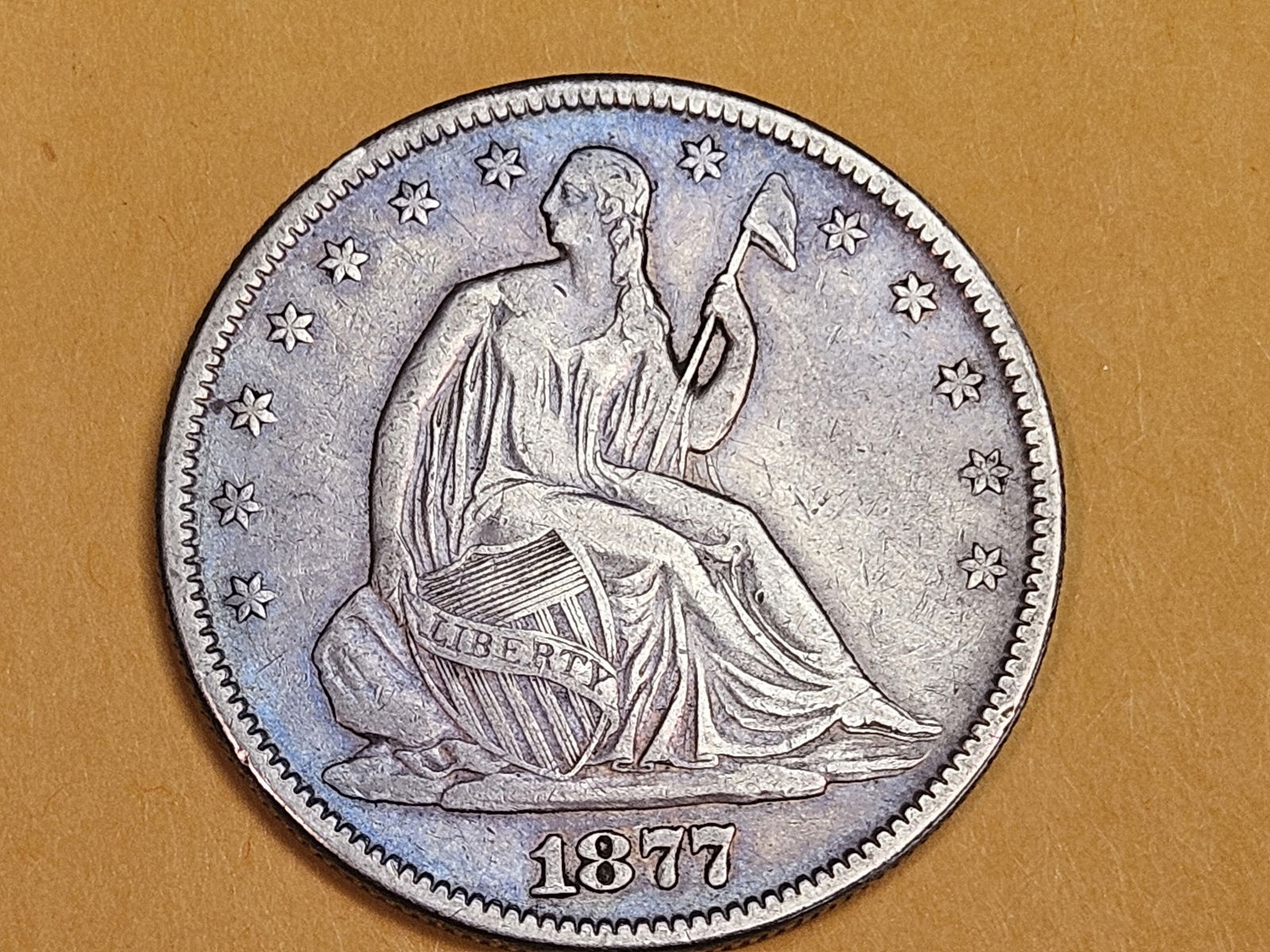 1877 Seated Liberty silver Half Dollar in Very Fine - 30: Cool toning 