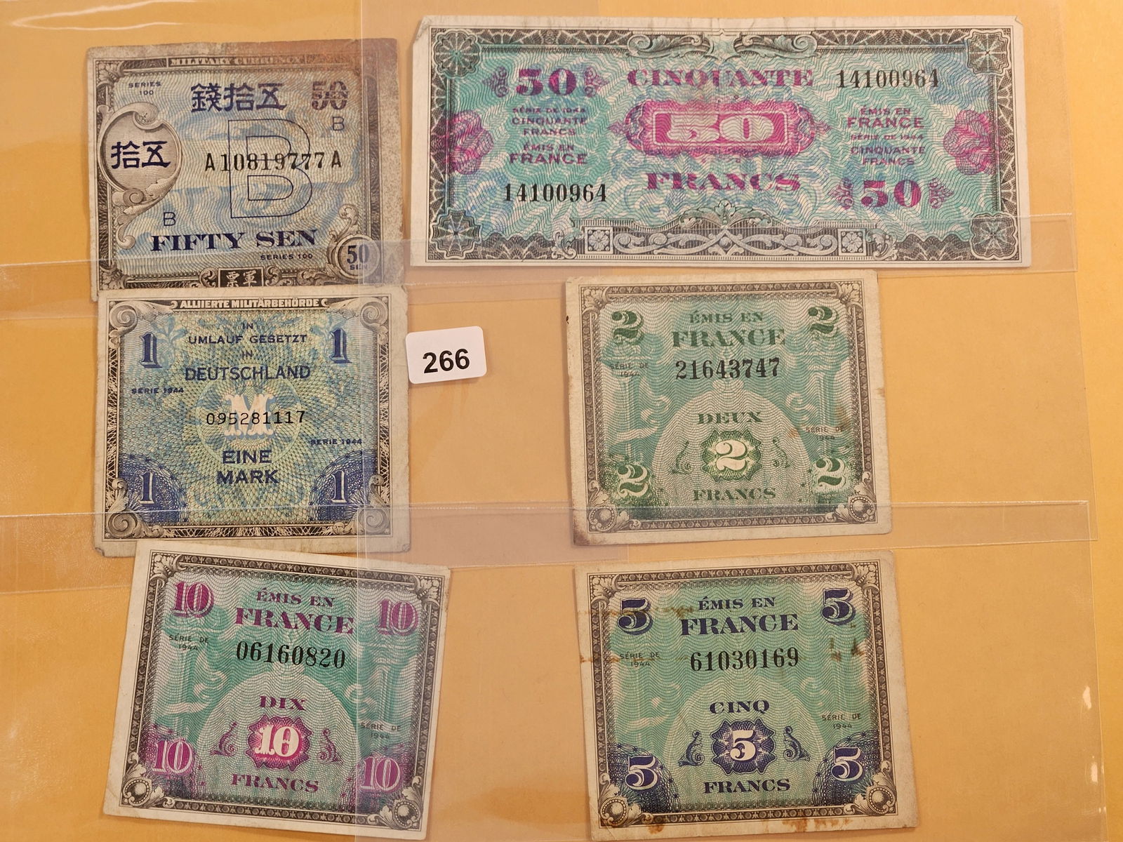 Six Circulated 1944 Allied Military Payment Certificates: Japanese Series 100 Fifty Sen, German One Mark, with French Fifty Francs, Ten Francs, Five Francs, Two Franks and One Franc 