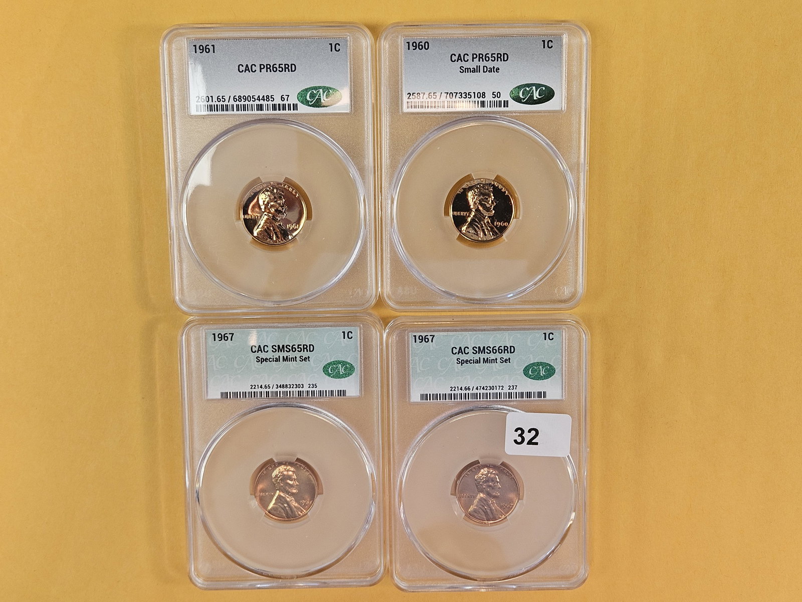 Four CACG-Graded Blazing Red Wheat cents: 1961 in PR 65 RED, 1960 in PR 65 RED, and two 1967 SMS in 65 and 66 RED 