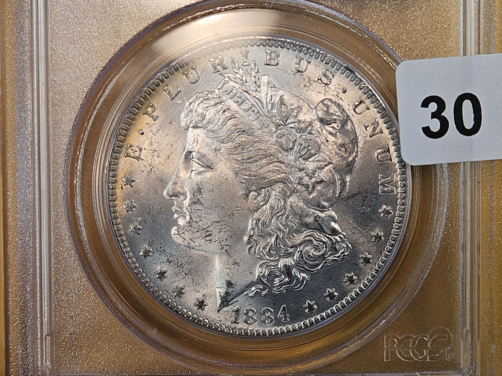 PCGS OGH 1884-O Morgan Dollar in Mint State 63: Old Green Holder 