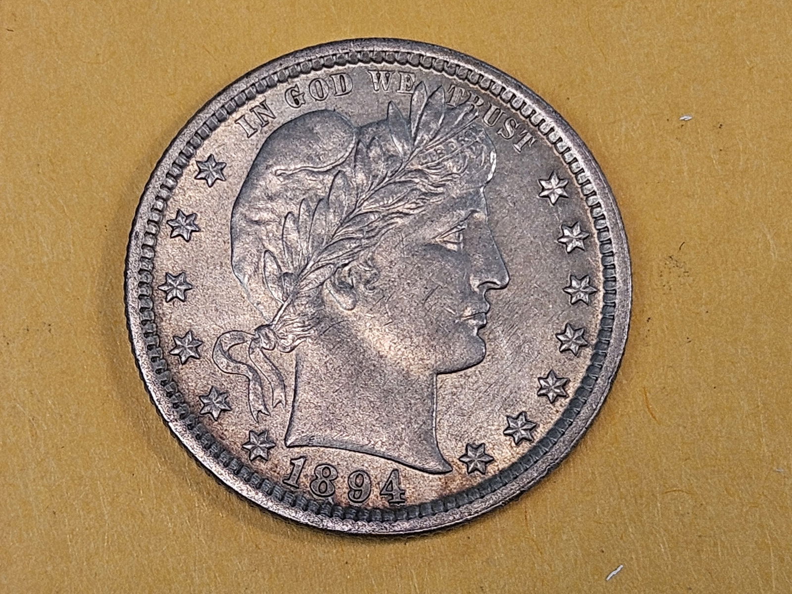 Pretty 1894 Barber Quarter in Bright Uncirculated condition: Very Attractive piece. Very light, hidden scratch by the wing on the reverse 