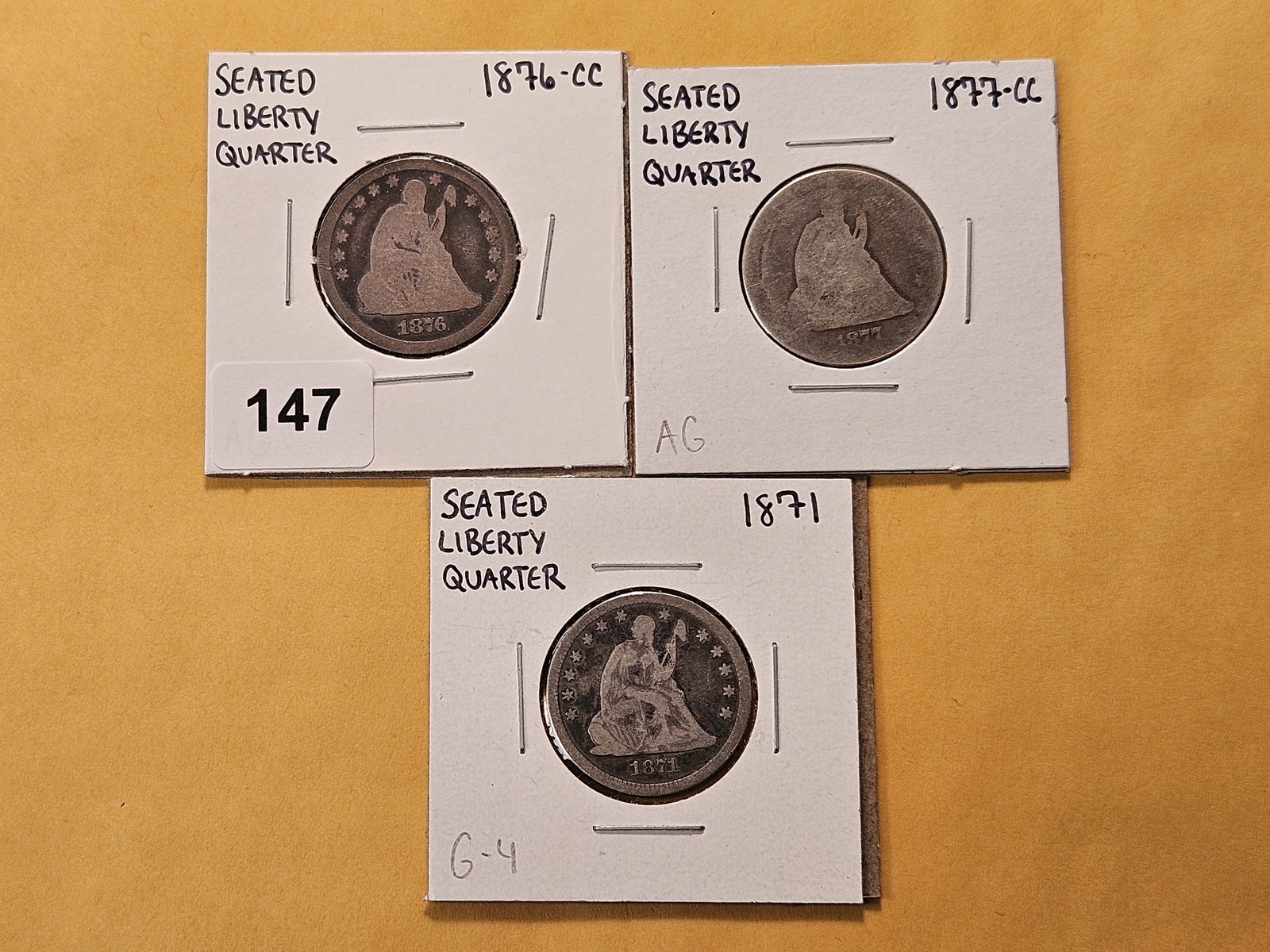 Three Circulated Seated Liberty Silver Quarters: 1871, 1876-CC and 1877-CC 