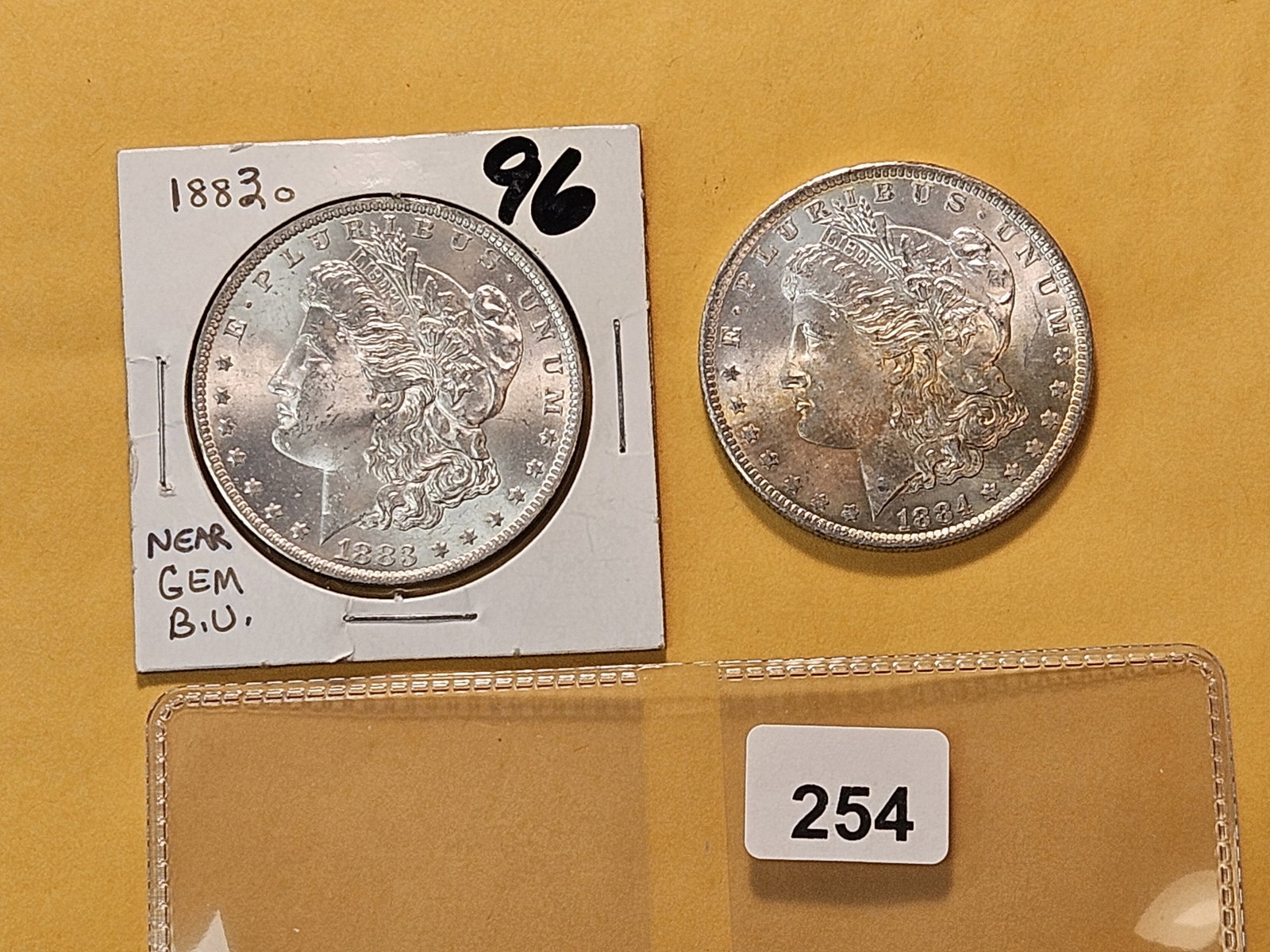Two Brilliant About Uncirculated plus Morgan Silver Dollars: 1883-O and 1884-O with nice toning 