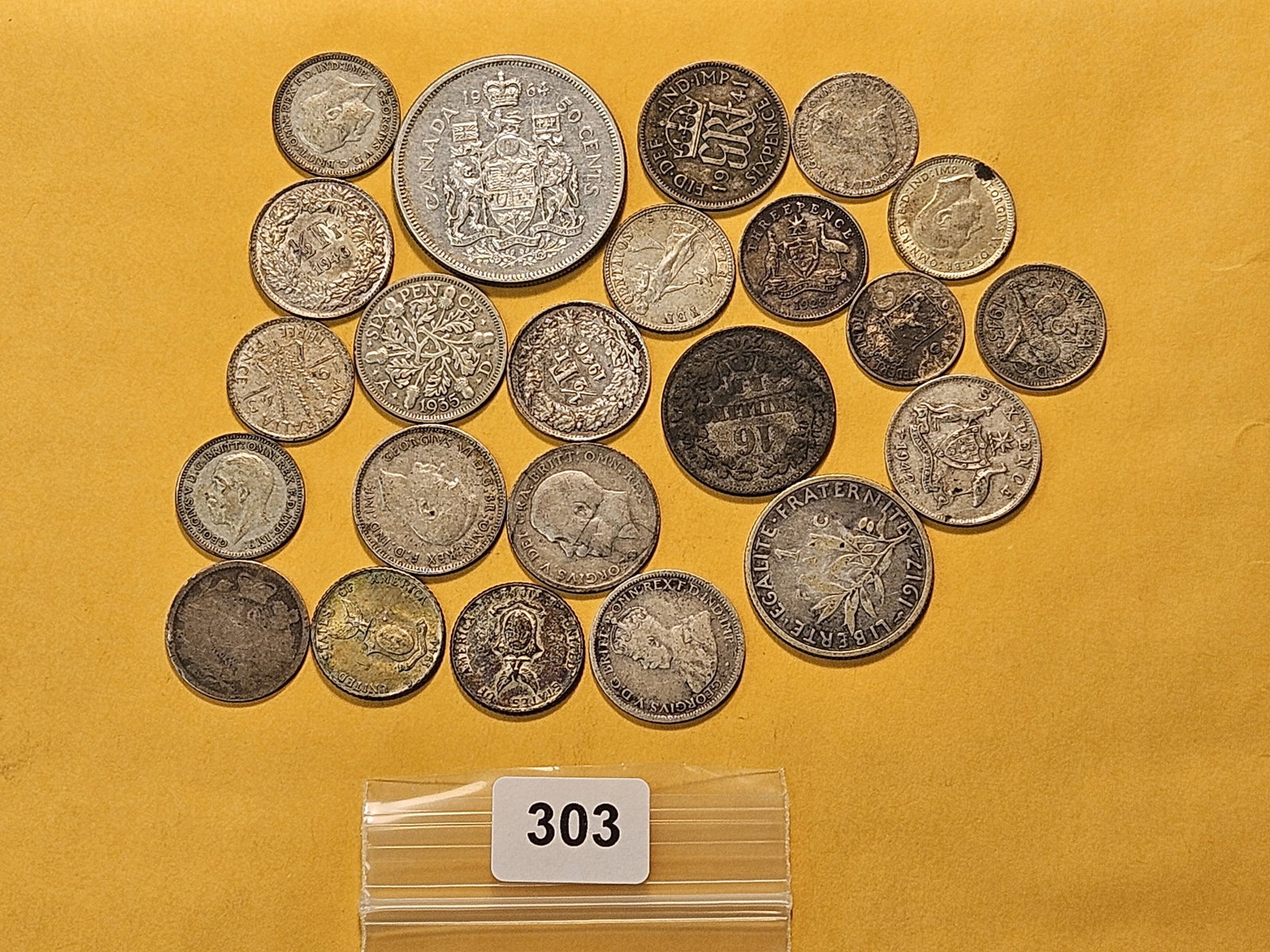 WORLD SILVER!: Twenty three mixed foreign Silver Coins. Most are small sized with one Canadian Half Dollar 