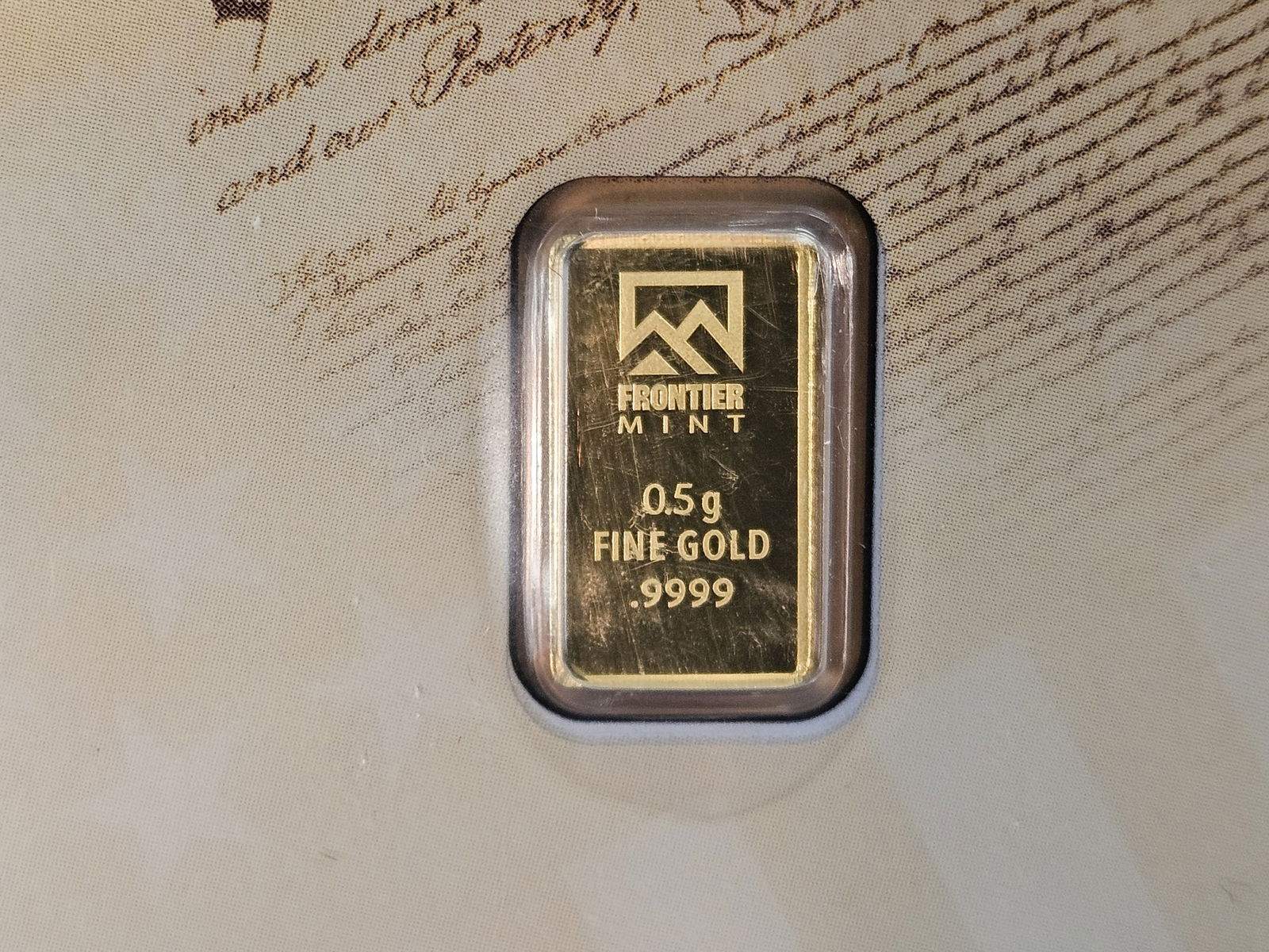 GOLD! Frontier Mint One-half Gram .9999 fine gold bar: In assay holder 