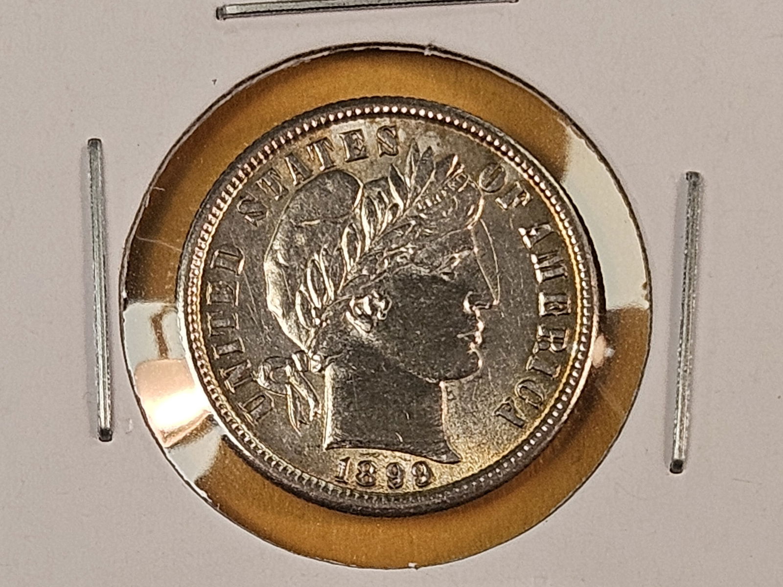 ** 1899 Barber Dime in Very Choice Brilliant Uncirculated: Gorgeous coin! Excellent eye appeal. Lightly toned 