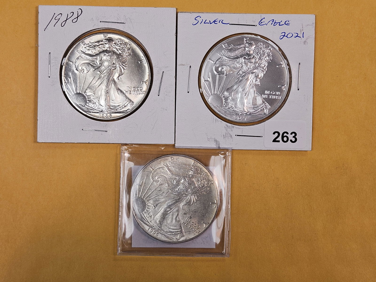 Three Brilliant Uncirculated American Silver Eagles: 1988, 2021, 1995 