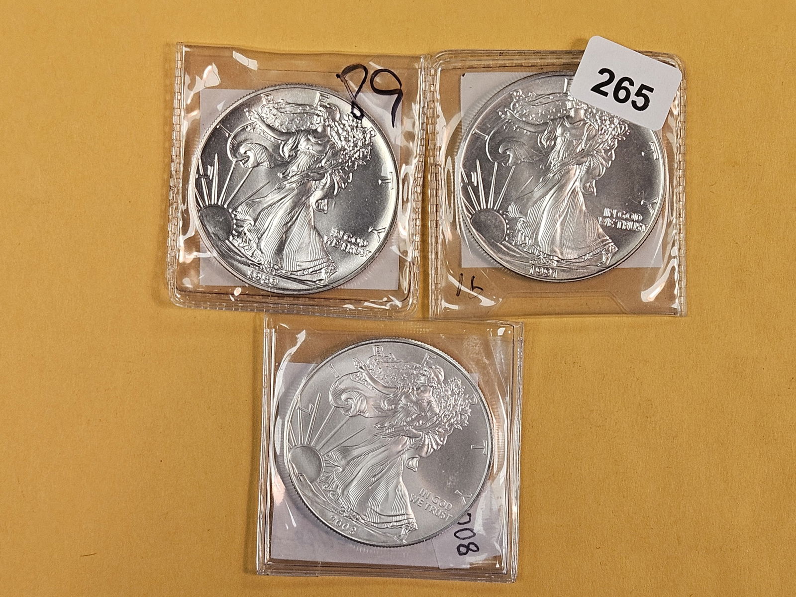 Three GEM Brilliant Uncirculated American Silver Eagles: 1989, 1991 and 2008 