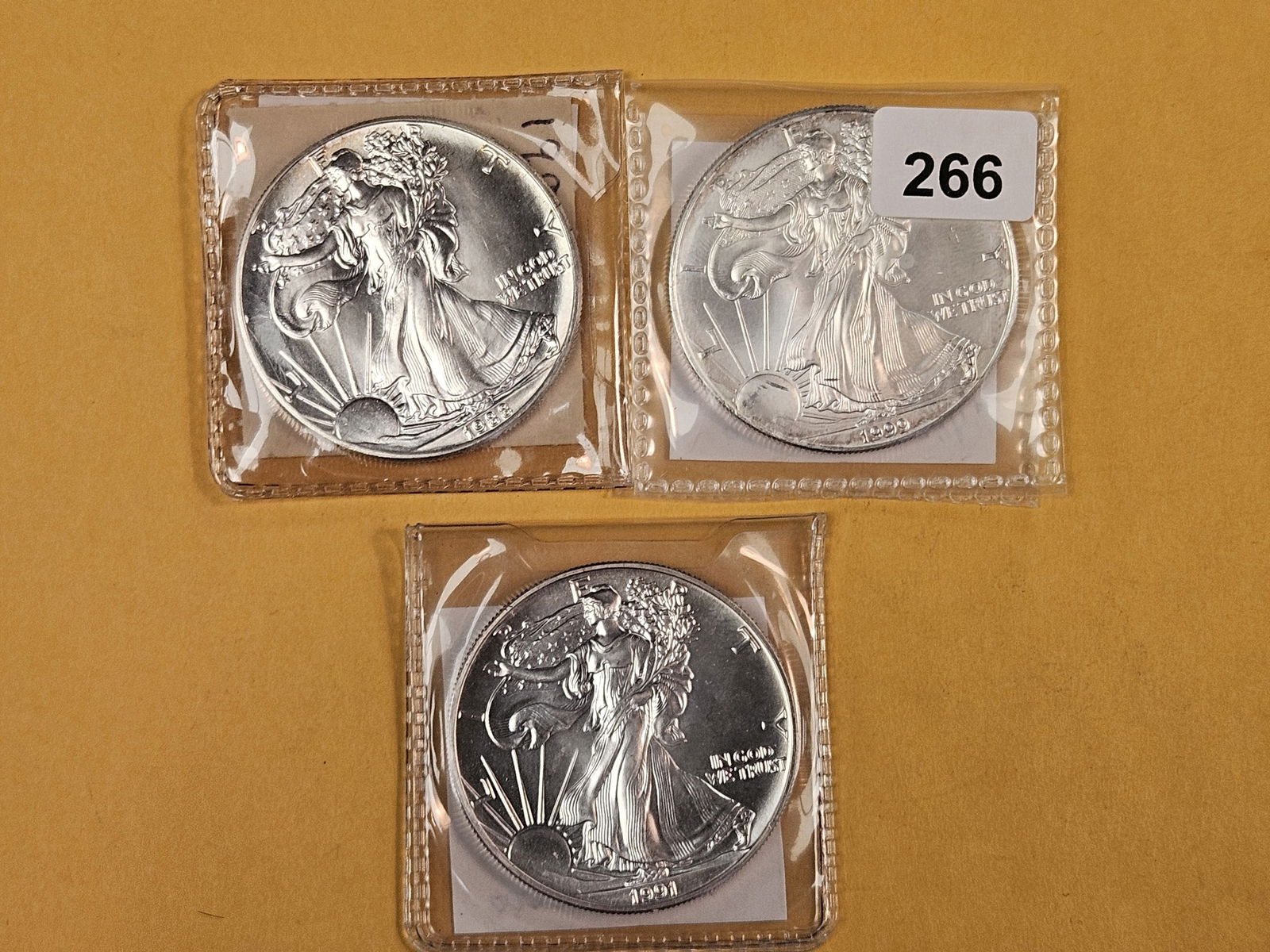 Three GEM Brilliant Uncirculated American Silver Eagles: 1988, 1999 and 1991 