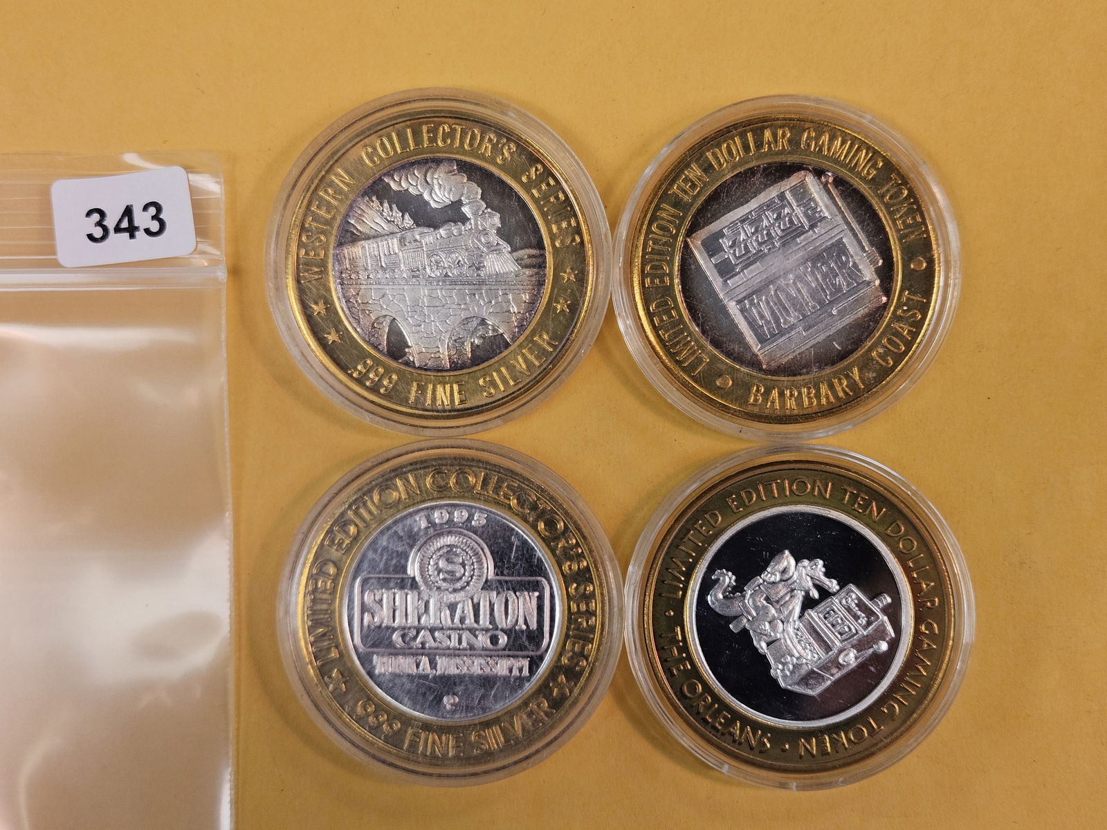 Four mixed GEM .999 fine silver center Casino Gaming Tokens: mixed. In plastic capsules 