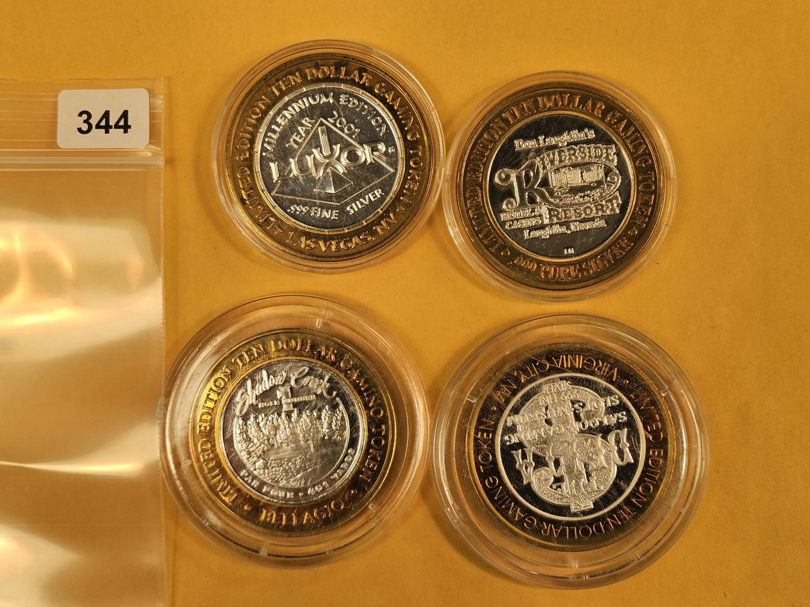 Four mixed GEM .999 fine silver center Casino Gaming Tokens: mixed. In plastic capsules 