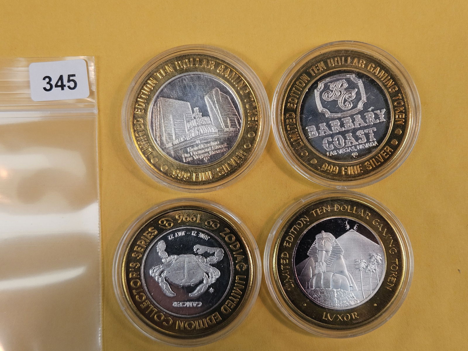 Four mixed GEM .999 fine silver center Casino Gaming Tokens: mixed. In plastic capsules 