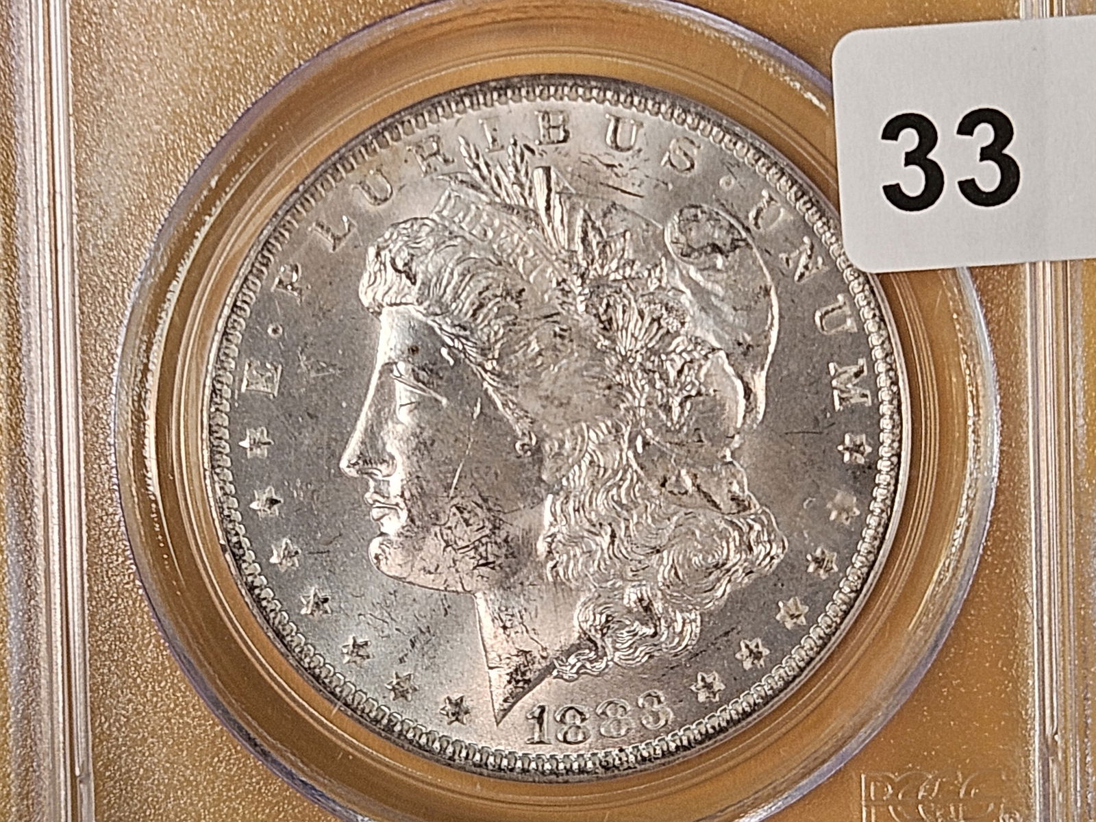 PCGS 1883-O Morgan Dollar in Mint State 63: Good luster 