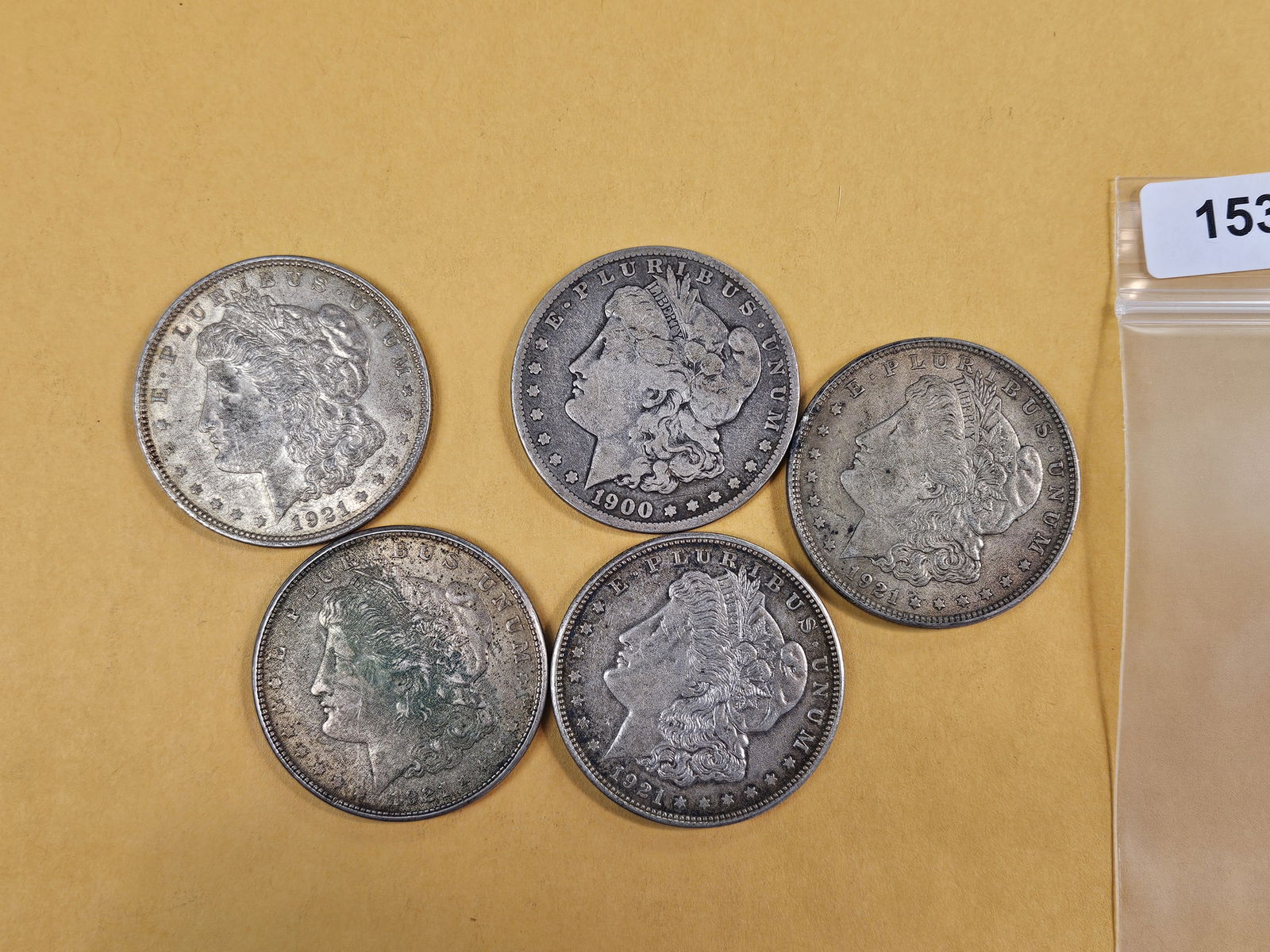 Five mixed Morgan Silver Dollars (1 of 2)