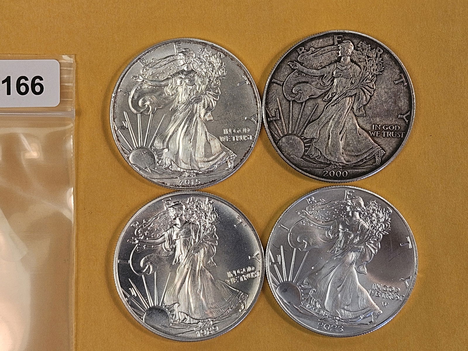 Four mixed American Silver Eagles: AU to BU 