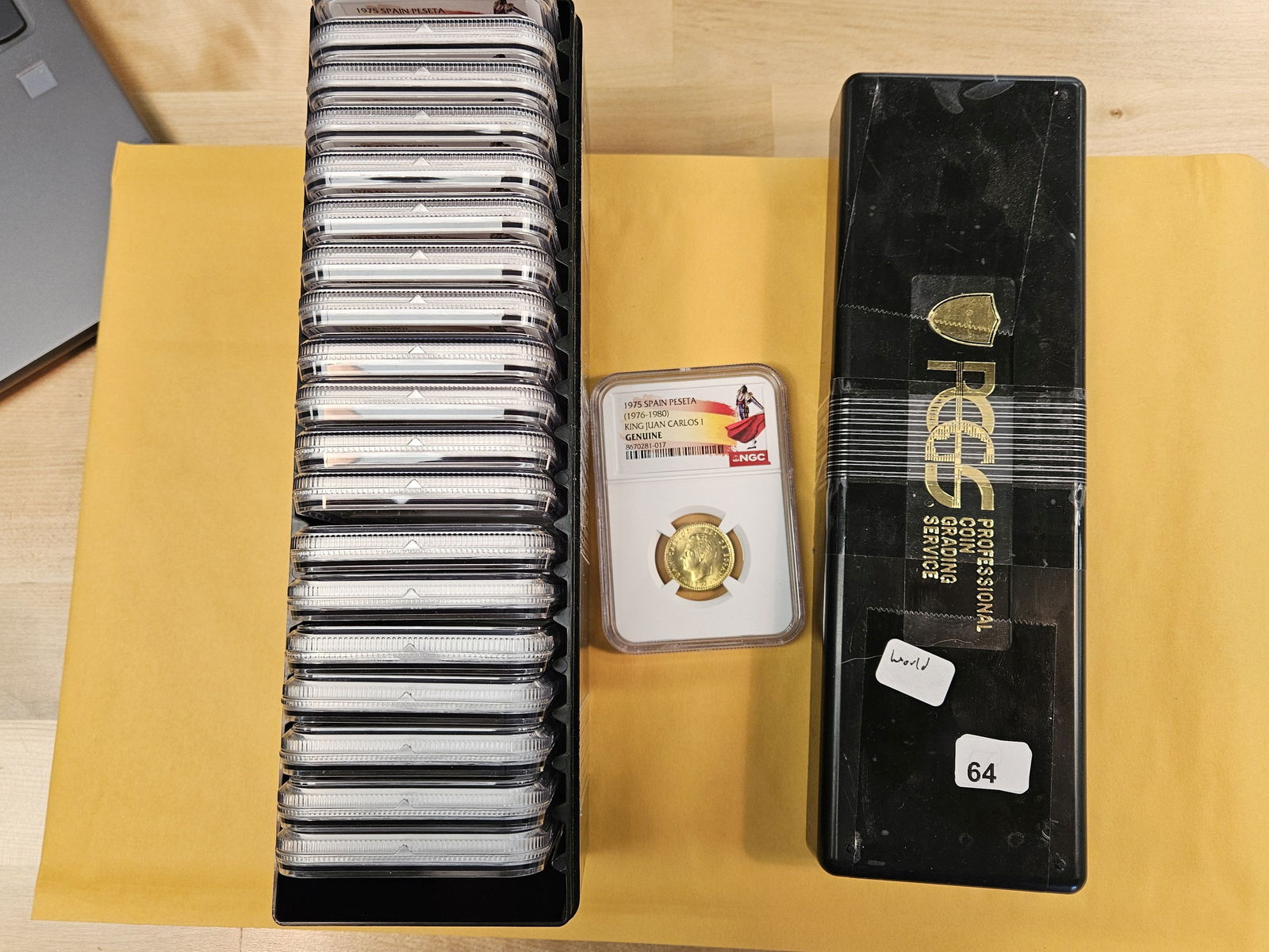 Full Box! Twenty NGC-graded 1975 Spain Peseta coins: All Graded Genuine. All look GEM BU. All the same. Comes in Black PCGS box 