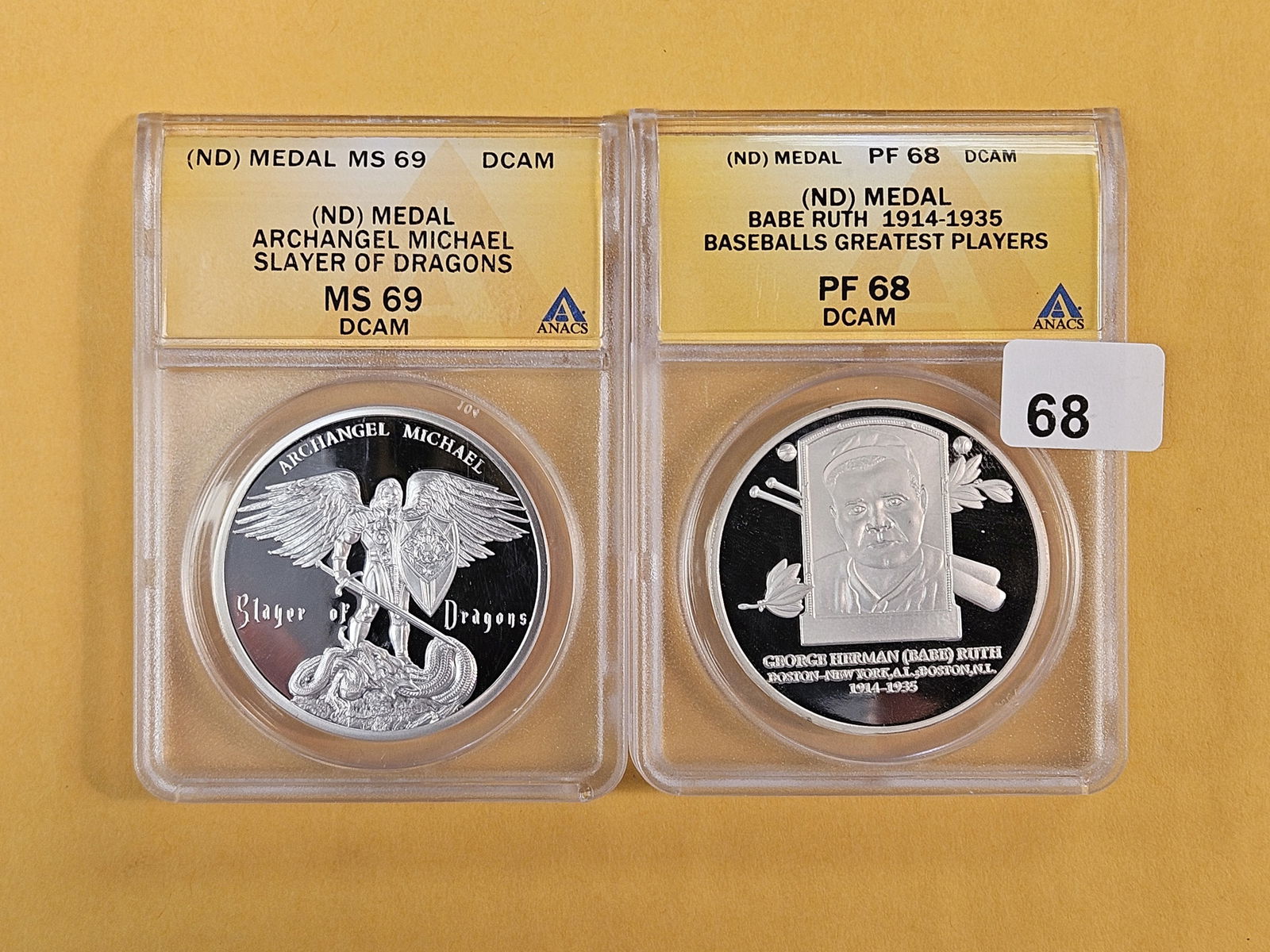 Two Near-Perfect ANACS-graded No-Date medals: Archangel Michel in MS-69 Deep Cameo and Babe Ruth in PF 68 Deep Cameo 